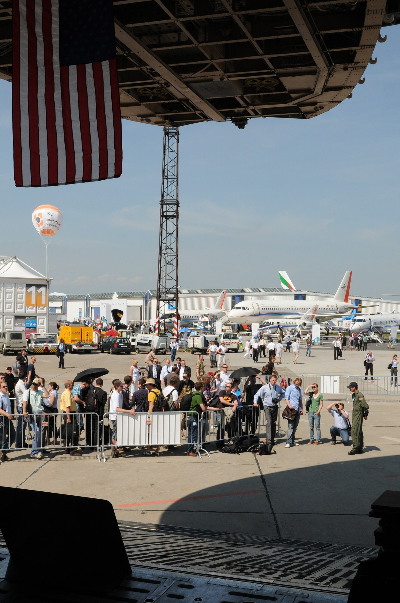 BERLIN -- Visitors wait to view the C-5 Galaxy during the ILA 2010 Berlin International Aerospace Exhibition and Conferences at the Berlin-Schoenefeld Airport June 9. The Berlin Air Show is one of the premier events of its kind, with more than 1,150 exhibitors from four countries, including the United States, presenting advanced technologies. (U.S. Air Force photo/Staff Sgt. Julius Delos Reyes)