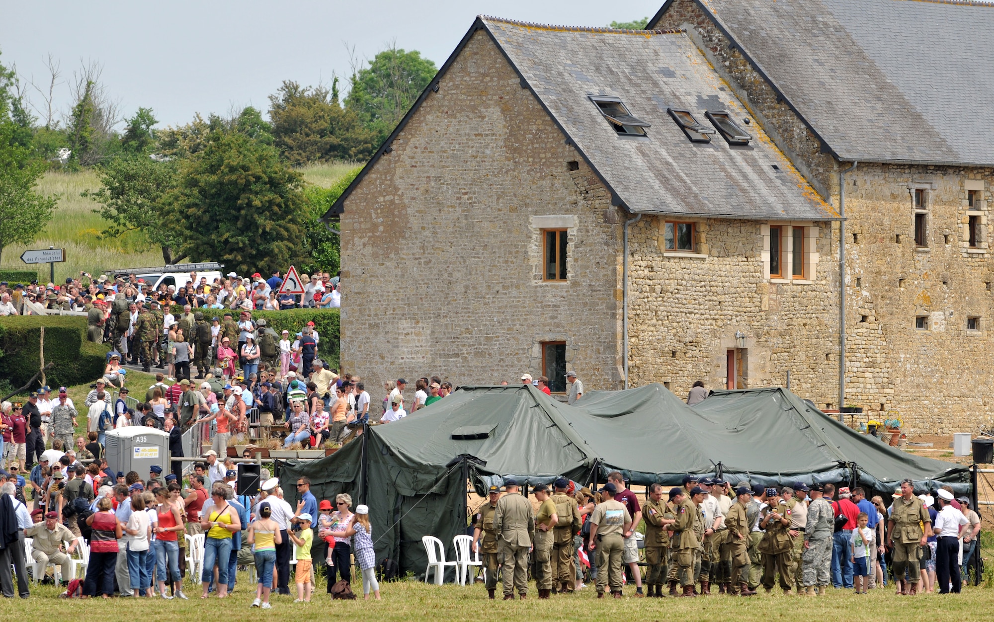 NORMANDY, France – A massive crowd of spectators gathers to watch multinational paratroopers jump into the famous “Iron Mike” drop zone June 5.  The jump was part of a ceremony commemorating the 66th anniversary of D-Day.  (U.S. Air Force photo/Staff Sgt. Austin M. May)