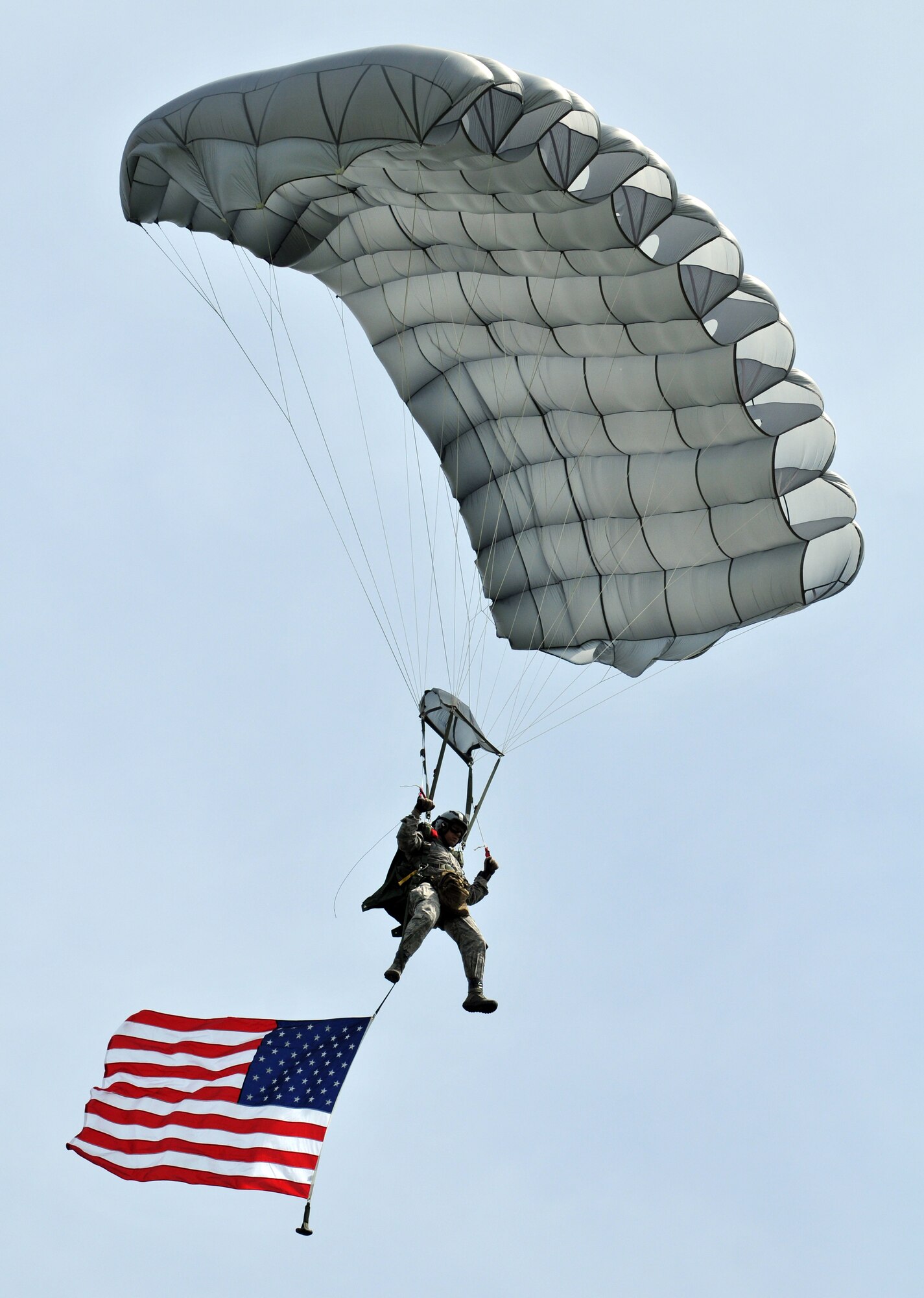 NORMANDY, France – A member of the 321st Special Tactics Squadron, RAF Mildenhall, England, flies the American flag over the famous “Iron Mike” drop zone, where the Allies first landed in the D-Day invasion of World War II, June 5.  The jump was part of a ceremony commemorating the 66th anniversary of D-Day.  (U.S. Air Force photo/Staff Sgt. Austin M. May)