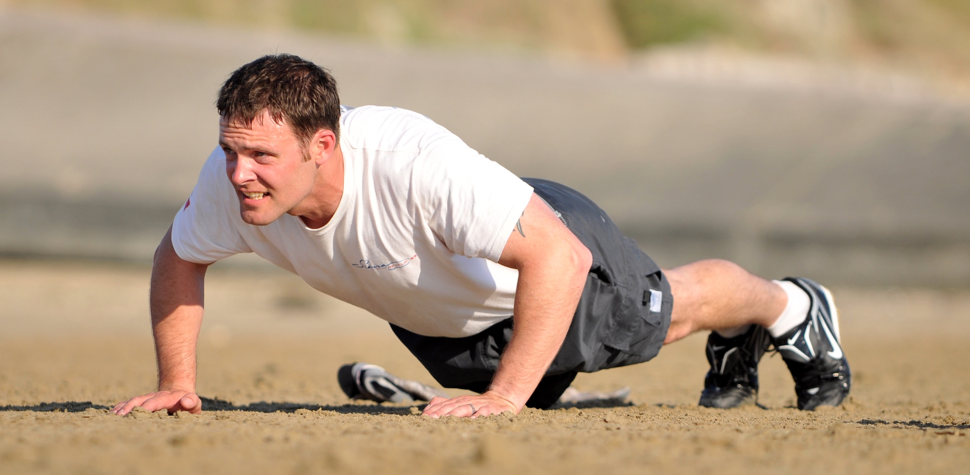 NORMANDY, France – A member of the 321st Special Tactics Squadron, RAF Mildenhall, England, does “Memorial Pushups” on Utah Beach, one of the sites of the Allied landing in Europe in World War II, June 4.  Special operations Airmen perform the ceremonial pushups to foster teamwork and honor their fallen comrades.  (U.S. Air Force photo/Staff Sgt. Austin M. May)