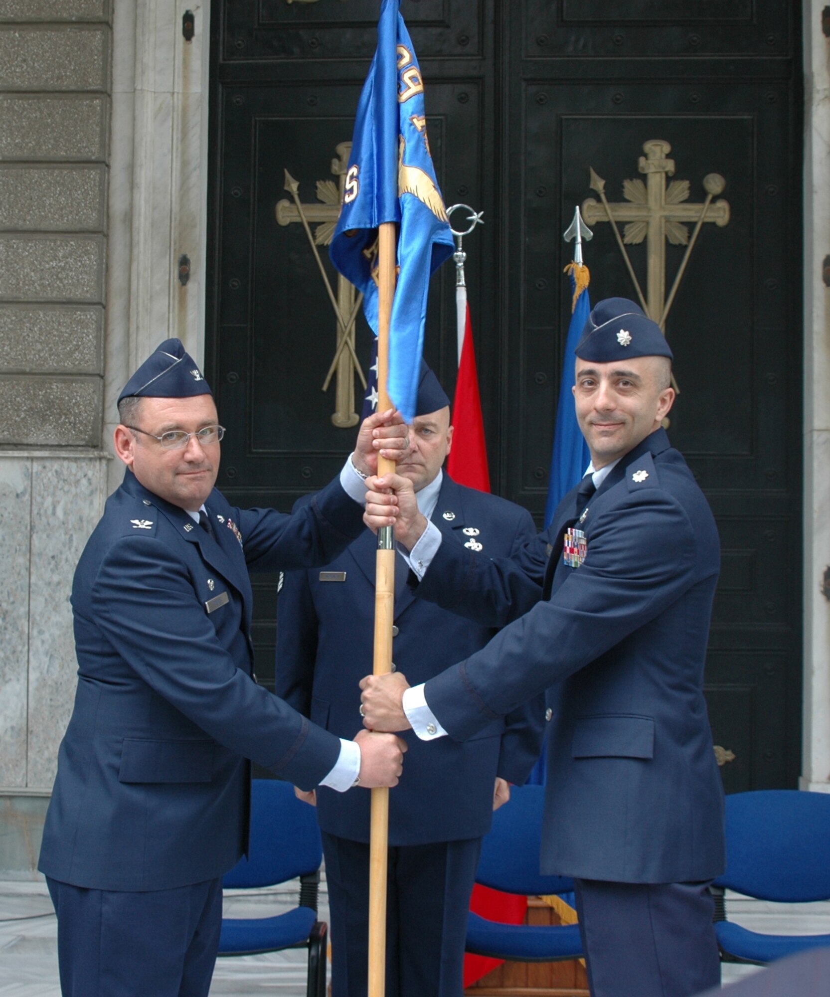 Lt. Col. Kenneth Marentette (right), accepts command of the 425th Air Base Squadron from Col. Andrew Pears, 39th Mission Support Group commander, during the change of command ceremony Monday, June 7, 2010 at the Izmir Chapel Garden in Izmir, Turkey. Master Sgt. Anthony Hanshaw, the 425th ABS first sergeant, stands ready to receive the guidon. Colonel Kenneth Marentette is the former Chief of Force Development Information Technology Integration, Directorate of Force Development, Deputy Chief of Staff Manpower, Personnel and Services, Headquarters United States Air Force, Pentagon, Washington, D.C. (U.S. Air Force photo/Tanju Varlikli)