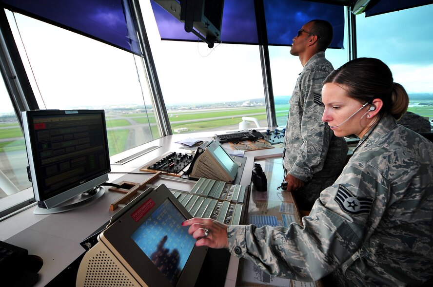 Staff Sgt. Michelle Hanna coordinates with Naha controllers for inbound and outbound aircraft while Tech. Sgt. Warren Allen, controls the aircraft taking off and landing at Kadena Air Base, Japan, June 9, 2010. Both individuals are from the 18th Operations Squadron. (U.S. Air Force photo/Tech. Sgt. Rey Ramon) 