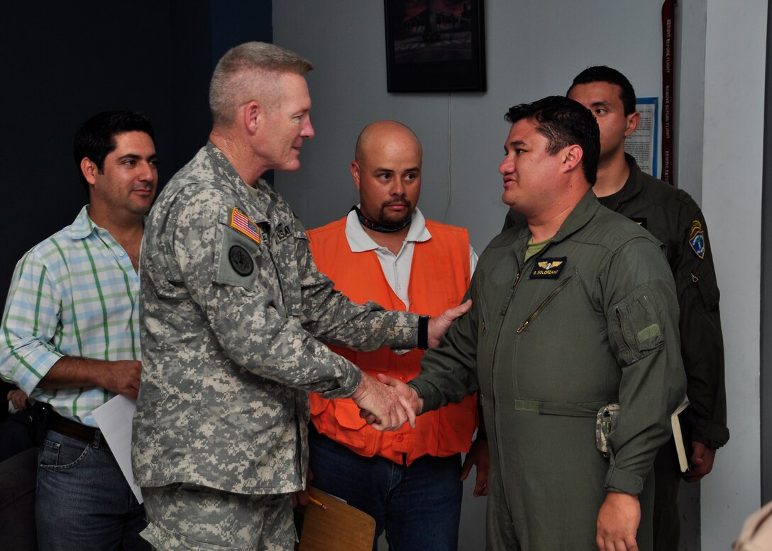 U.S. Air Force Col. Gregory Reilly, commander of Joint Task Force-Bravo, thanks 1st Lt. Guillermo Solorzano, Guatemalan air force liaison officer for the task force, for his efforts in helping military aircraft provide humanitarian aid to communities, June 4, 2010. 