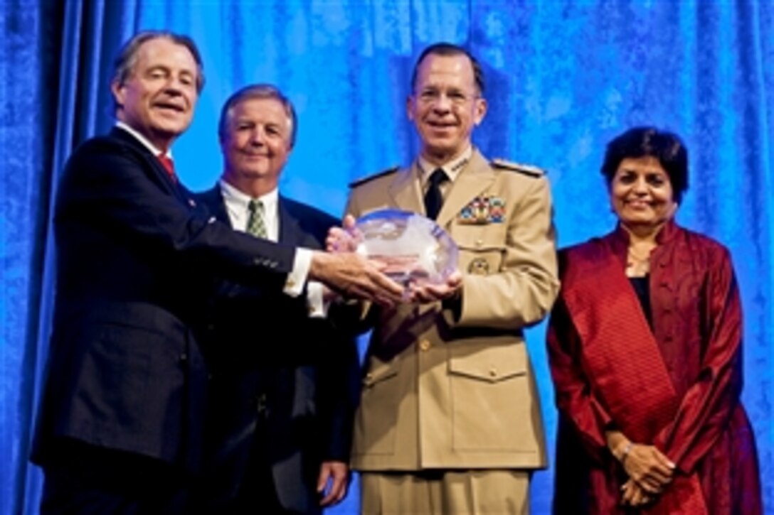 Leo A. Daly III, chairman of the Asia Society Washington, far left, presents U.S. Navy Adm. Mike Mullen, chairman of the Joint Chiefs of Staff, with the Public Policy Leadership Award on behalf on the U.S. armed forces at the organization's awards dinner in Washington, D.C., June 9, 2010.  Charles R. Kaye, Asia Society Washington awards dinner chairman, and Asia Society President Vishakha N. Desa, right, joined in the presentation.