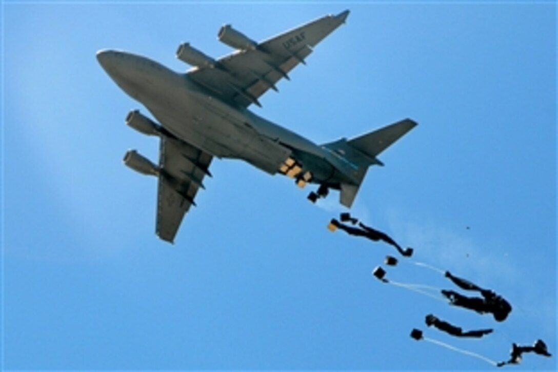 A U.S. Air Force C-17 Globemaster III aircraft drops cargo over Forward Operating Base Baylough, Afghanistan, June 10, 2010. The cargo drop was to support Company D, 1st Battalion, 4th Infantry Regiment.