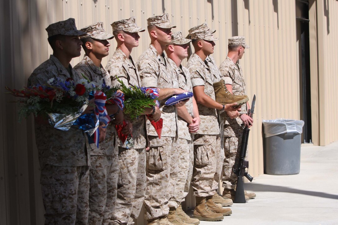 Members of 3rd Battalion, 4th Marine Regiment, prepare to build memorials June 11 at Lance Cpl. Torrey L. Gray Field for Lance Corporals Joshua Birchfield and Cody Stanley, who sacrificed their lives in Afghanistan. ::r::::n::