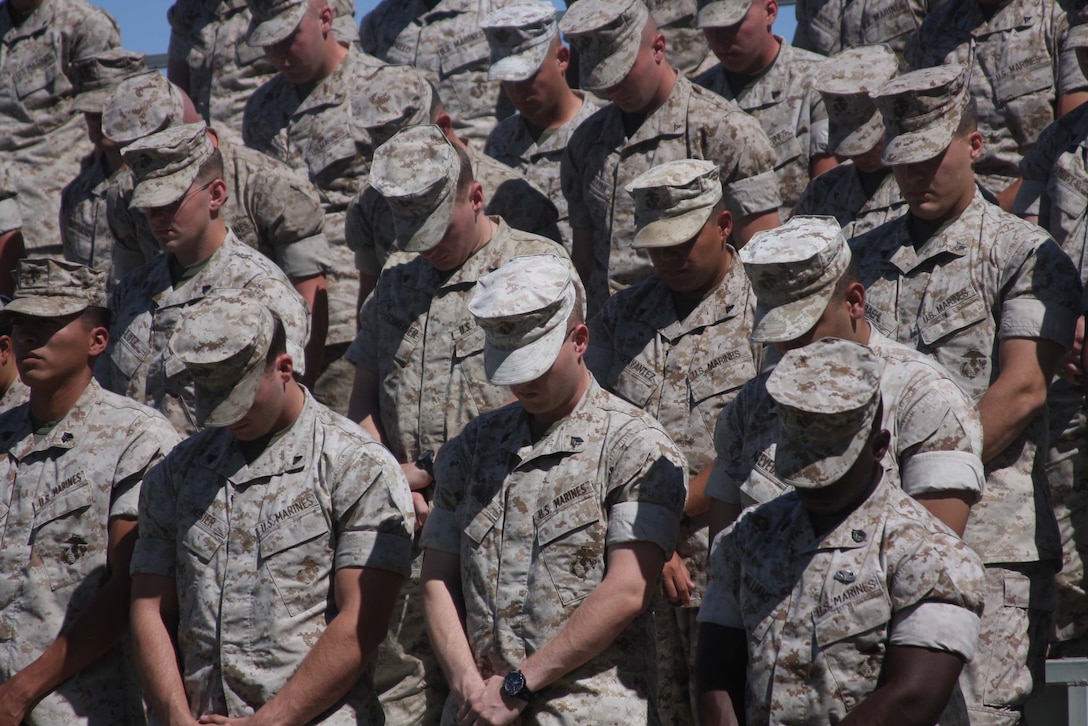 Marines bow in prayer as they honor their fallen brothers during a memorial ceremony at Lance Cpl. Torrey L. Gray Field June 11. The ceremony was to honor Lance Cpls. Joshua Birchfield and Cody Stanley from 3rd Battalion, 4th Marine Regiment, who were killed while conducting combat operations in Afghanistan.