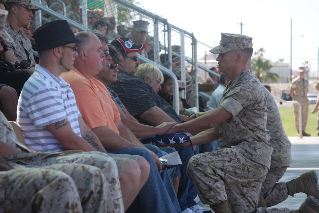 Lance Cpl. Joshua Birchfield’s family members are given folded American flags during a memorial service June 11 at Lance Cpl. Torrey L. Gray Parade Field in honor of Birchfield, who made the ultimate sacrifice in Afghanistan Feb. 19.