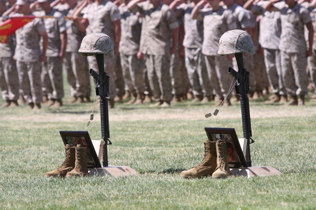 Dog tags attached to memorials blow in the wind during a memorial ceremony at Lance Cpl. Torrey L. Gray Field June 11 to honor Lance Corporals Joshua Birchfield and Cody Stanley, both Marines from 3rd Battalion, 4th Marine Regiment, who gave their lives in Afghanistan. Stanley belonged to Weapons Company, and Birchfield belonged to Company K.::r::::n::