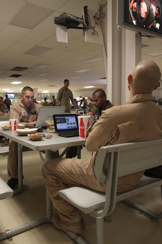 Members of Marine Heavy Helicopter Squadron 366 surf the Web on the Warriors Club’s free, wireless Internet and watch one of the Club’s TVs June 11. The Club also has outlets the service members can use to charge their electronic devices.