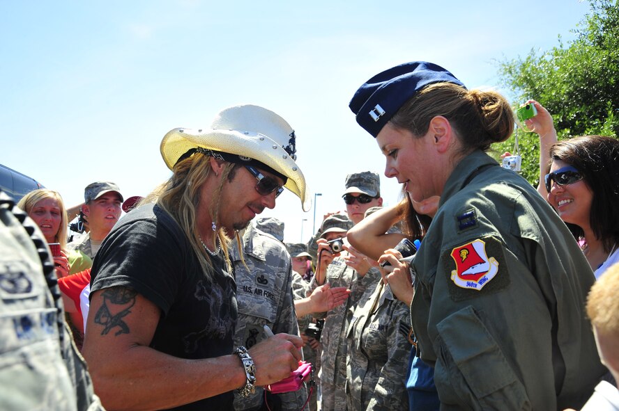 Capt. Tracey Nicks, 701st Combat Operations Squadron, March Air Reserve Base, Calif., receives an autograph from Bret Michaels at the Hurlburt Field Base Exchange parking lot during his visit to Hurlburt Field, Fla., June 11, 2010.  (DoD photo by U. S. Air Force Senior Airman Sheila deVera/Released)