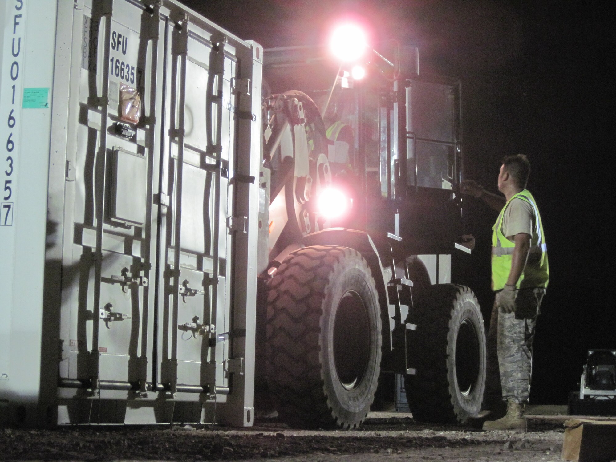 Tech. Sgt. Clifford Walton, 567th RED HORSE Squadron structures journeyman, directs the placement of a sea-land container at the temporary encampment that will house more than 250 Airmen, Soldiers, and Marines for New Horizons Panama 2010.  (U.S. Air Force photo/Senior Airman Emily Buckner)