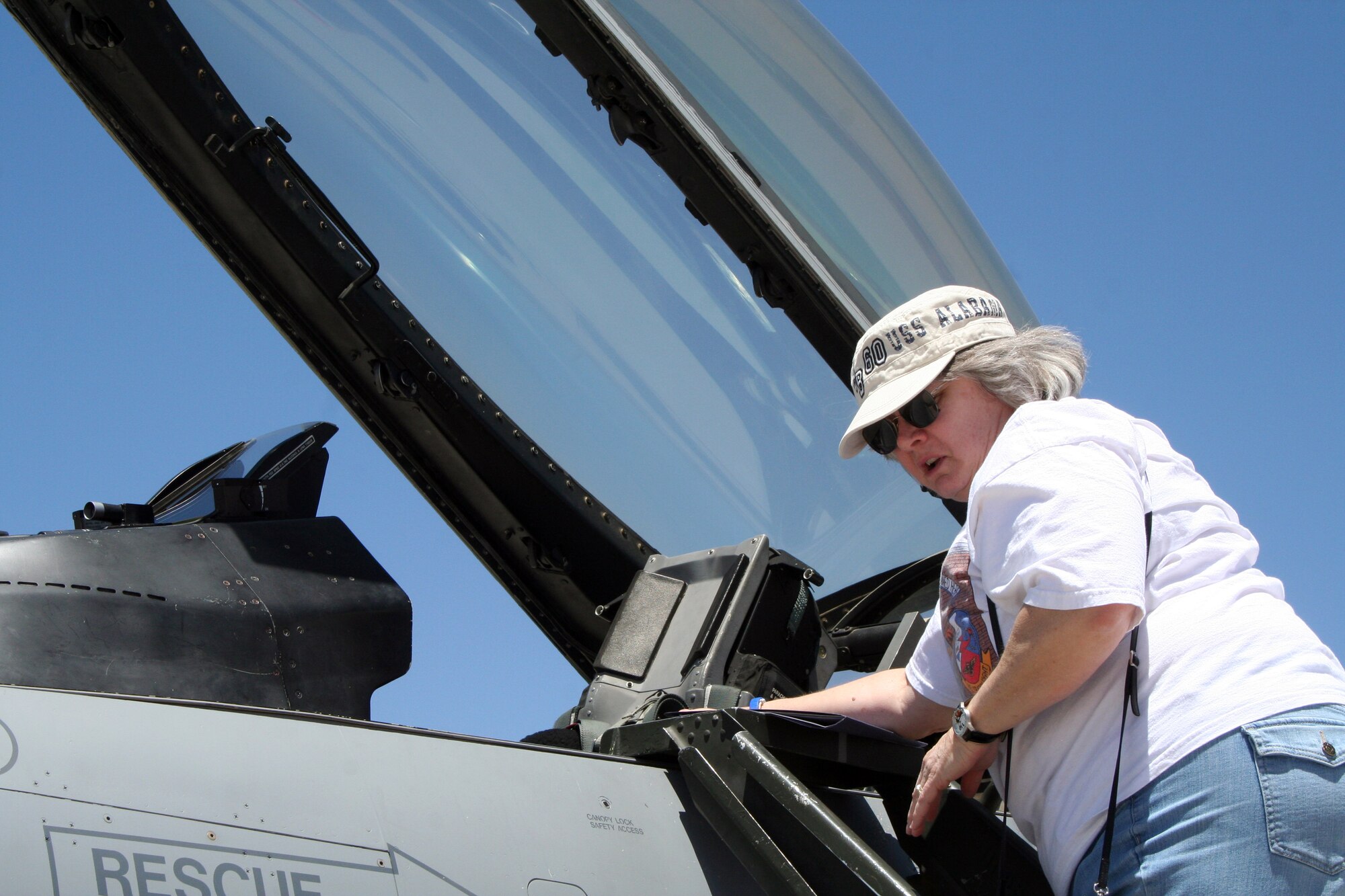 Cheri Bibeau looks into the cockpit of an F-16 from the New Mexico Air National Guard during a recent visit of the Blue Star Mothers. Photo by Penny Huston