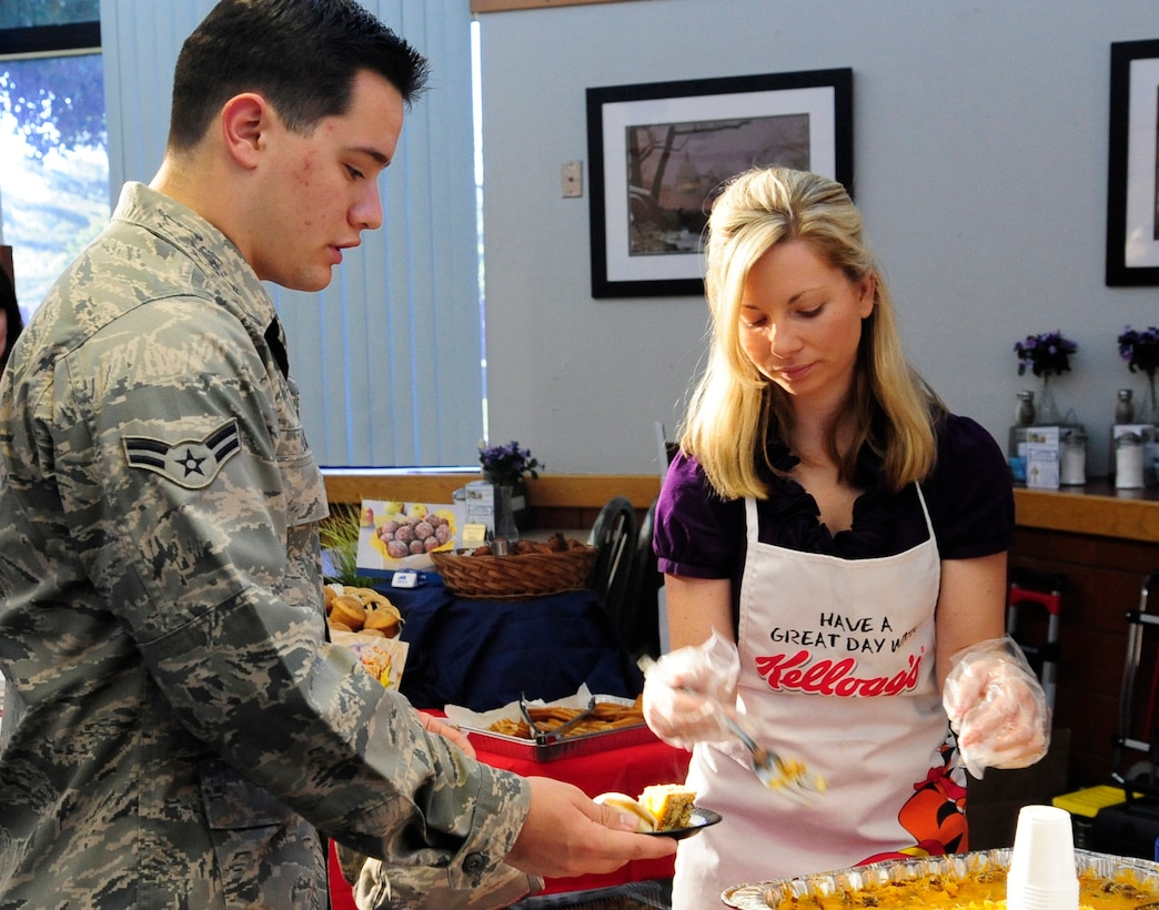 JOINT BASE ANDREWS, Md. -- Katie Duggan, Kellogg representative, serves a Frittata sample to Airman 1st Class Christopher Eck, 316th Force Support Squadron customer service representative, during a breakfast food tasting event Freedom Hall Dinning Facility June 8. Food sampling allows Joint Base Andrews customers to sample new items and vote on whether or not it should be served in the Dining Facility.  (U.S. Air Force photo by Staff Sgt. Keyonna Fennell)