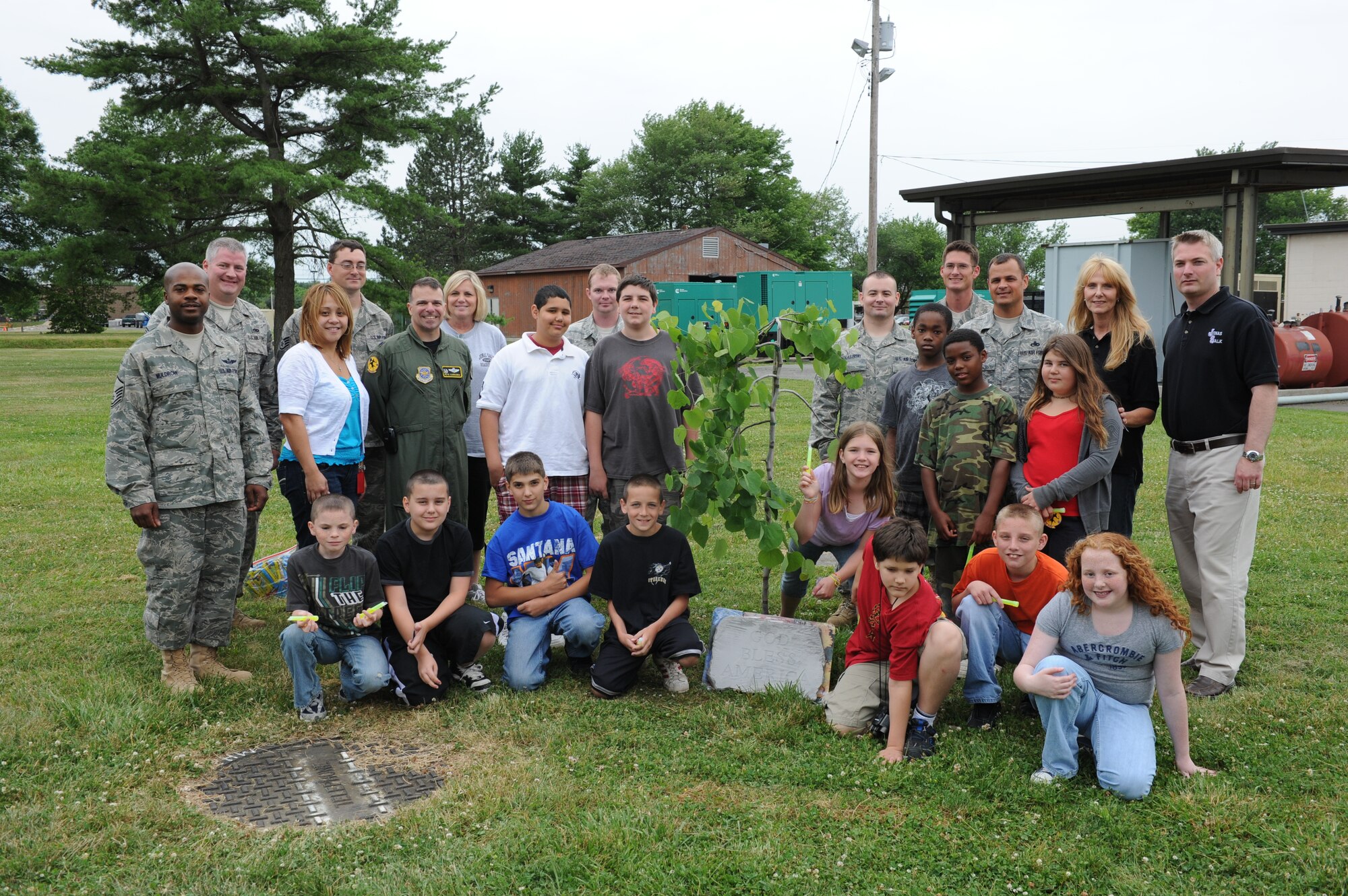 JOINT BASE MCGUIRE-DIX-LAKEHURST, N.J. -- Sixth-grade students from Jonas Salk Middle School present members of the 818th Global Mobility Squadron with a tree and plaque during a tour here June 9.  The 621st Contingency Response Wing's 818th Global Mobility Squadron invited 16 special education students from Jonas Salk Middle School in Old Bridge, N.J. to visit the base for a tour of aircraft, facilities and equipment. (U.S. Air Force photo by Tech. Sgt. Laura K. Deckman)(released)
