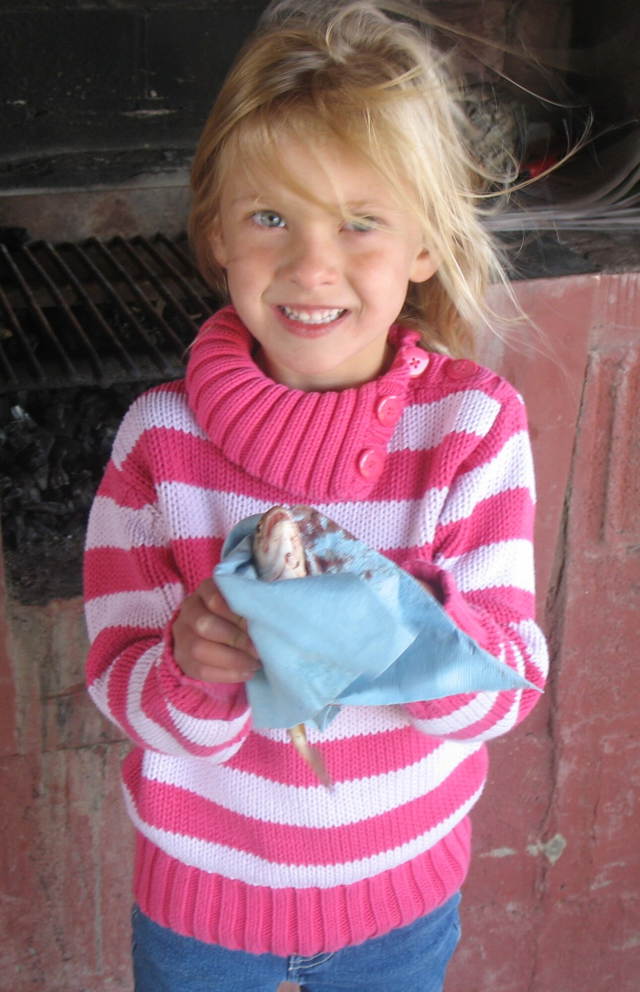 Kyliss Hassel timidly holds a trout she caught June 5 at Pow Wow Park pond. Seventy-two children participated in the annual event and 33 fish were caught. (Courtesy photo)