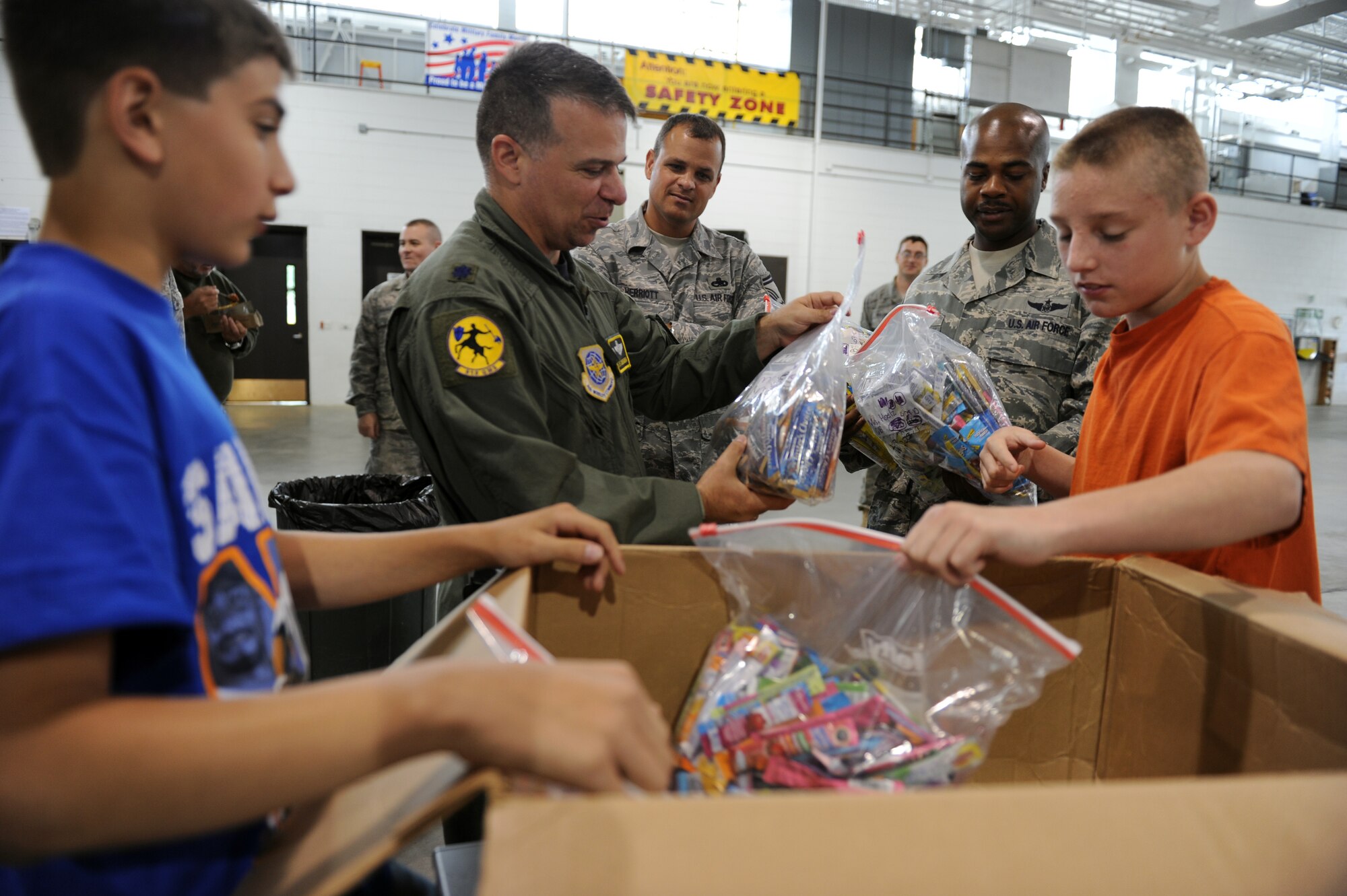 JOINT BASE MCGUIRE-DIX-LAKEHURST, N.J. -- Sixth-grade students from Jonas Salk Middle School present members of the 818th Global Mobility Squadron with drink mix packets and other non-perishable items during a tour here June 9.  The 621st Contingency Response Wing's 818th Global Mobility Squadron invited 16 special education students from Jonas Salk Middle School in Old Bridge, N.J. to visit the base for a tour of aircraft, facilities and equipment. (U.S. Air Force photo by Tech. Sgt. Laura K. Deckman)(released)
