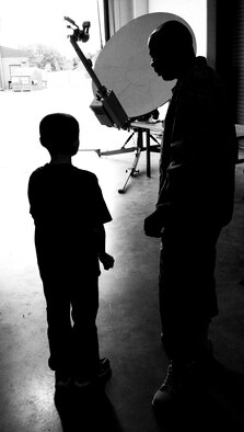 JOINT BASE MCGUIRE-DIX-LAKEHURST, N.J. -- Master Sgt. Lashone Muldrow, 818th Global Mobility Squadron contingency response team leader talks with his pen pal, Shawn Hartford, sixth-grade student at Jonas Salk Middle School through the during a tour here June 9.  The 621st Contingency Response Wing's 818th Global Mobility Squadron invited 16 special education students from Jonas Salk Middle School in Old Bridge, N.J. to visit the base for a tour of aircraft, facilities and equipment. (U.S. Air Force photo by Tech. Sgt. Laura K. Deckman)(released)
