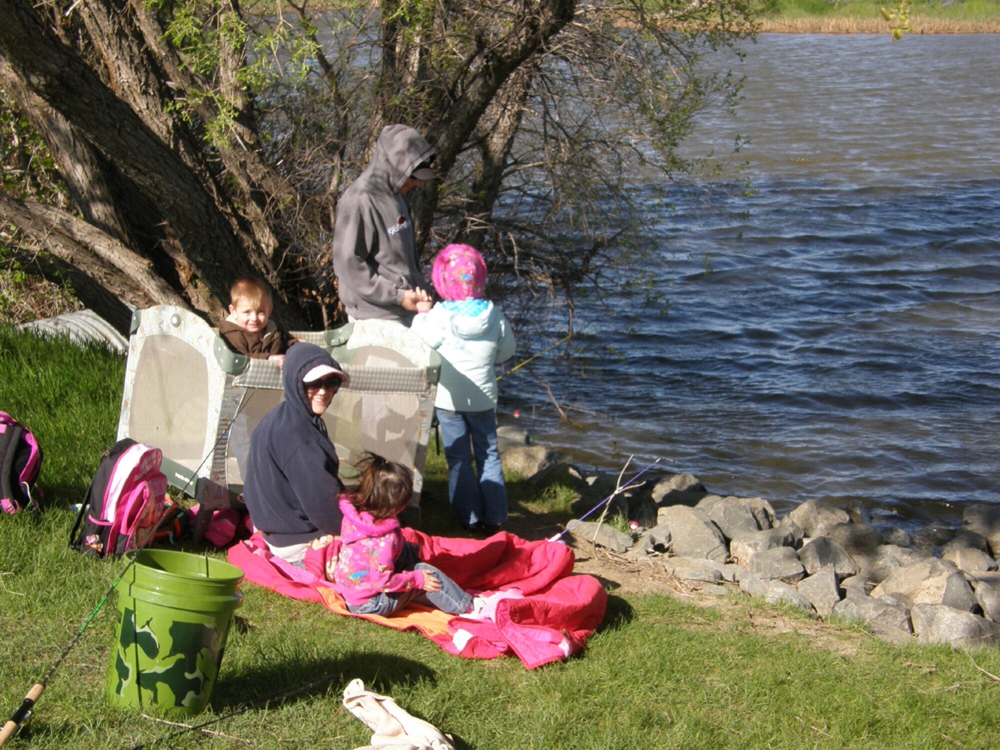 A Team Malmstrom family gets comfortable on the shorebank of Pow Wow Pond June 5 during National Kid's Fishing Day. (Courtesy photo)