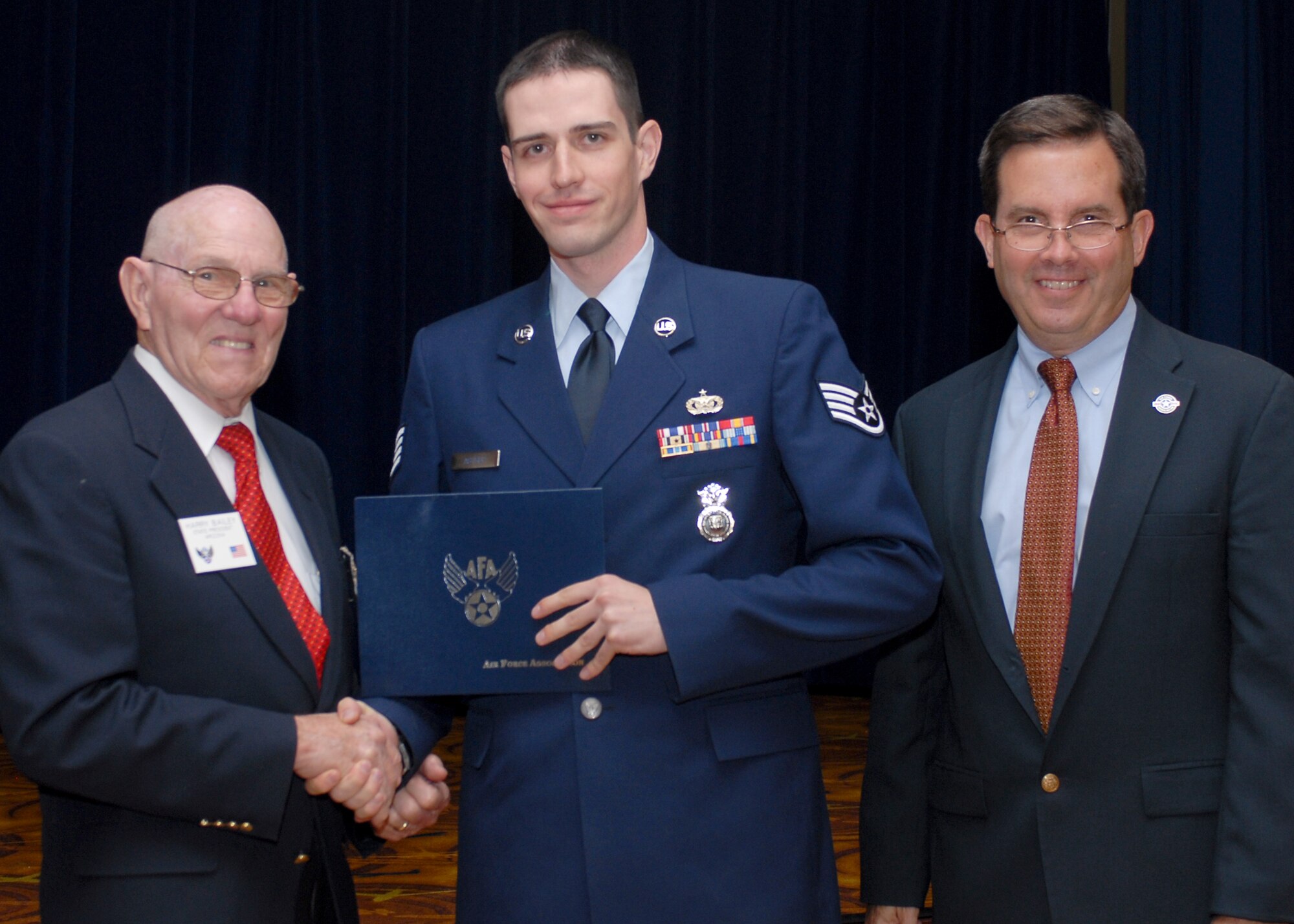 Staff Sgt. Zachary Astrup, 944th Security Forces Squadron fire team member, recieves the Air Force Association Pitsenbarger Award during a Community College of the Air Force graduation ceremony June 3 at Luke Air Force Base, Ariz. The award provides a one-time grant of $400 to selected top enlisted personnel graduating from CCAF who plan to pursue a baccalaureate degree. Selection for the award is determined by a committee that considers job performance, scholastic achievement, education goals and leadership qualities. 