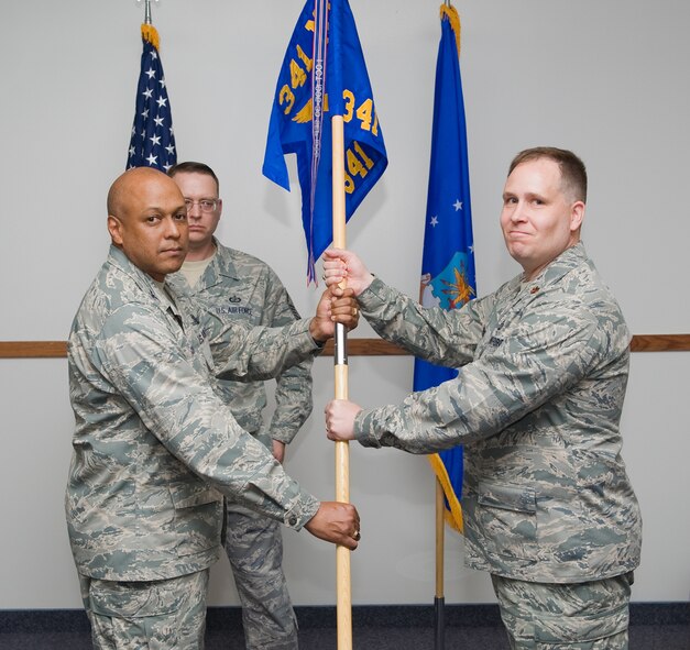 Maj. David Stephens accepts command of the 341st Comptroller Squadron from Col. Anthony Cotton, 341st Wing Commander, June 4 2010 at the Chapel Annex. Master Sgt. Rodney Martin, 341st CPTS first sergeant,  looks on. ( U.S. Air Force photo / Beau Wade)