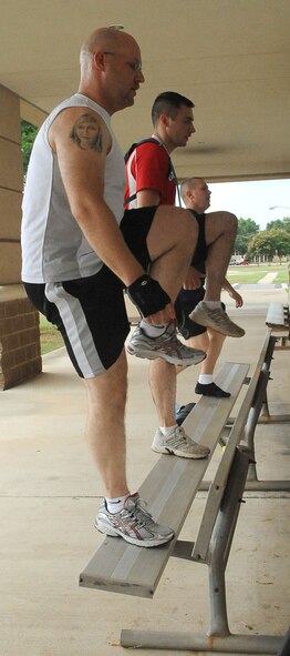 BARKSDALE AIR FORCE BASE, La. -- Airmen perform "step ups" on a bench during the Health and Wellness Center?s basic training class June 9. The class is designed to improve an individual's overall health and physical fitness and is held 5:15 p.m. Monday through Thursday in front of the base fitness center. (U.S. Air Force photo/Senior Airman Amber Ashcraft) (RELEASED)