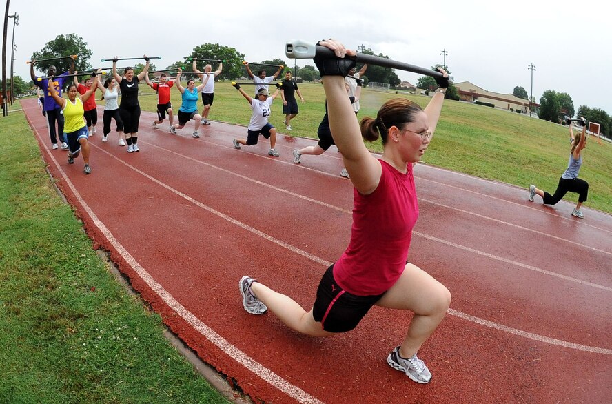BARKSDALE AIR FORCE BASE, La. ? Barksdale members perform walking lunges during the Health and Wellness Center?s basic training class June 9. The class is designed to improve an individual's overall health and physical fitness and is held 5:15 p.m. Monday through Thursday in front of the base fitness center. (U.S. Air Force photo/Senior Airman Amber Ashcraft) (RELEASED)