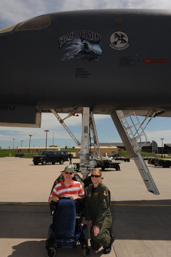 ELLSWORTH AIR FORCE BASE, S.D.-- Wade Ginkens poses with Captain Kristen "Flare" Jenkins, B-1B Lancer pilot and "Aircrew for a Day"  project coordinator, during his visit here June 10. Wade participated in the program which gives children  a chance to forget about their illness for a day and enjoy being a kid. (U.S. Air Force photo/Master Sgt. Loren J. Bonser)

