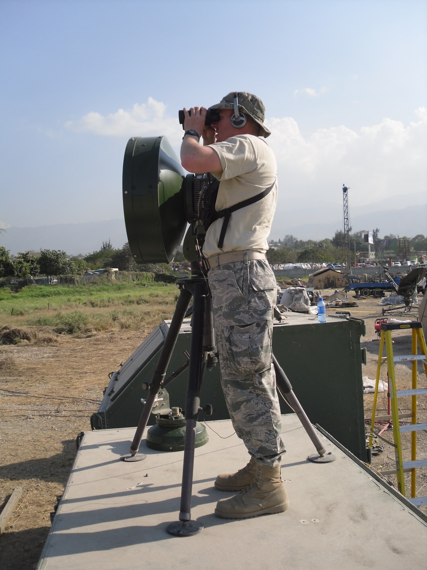 First Lt. Jake Cadwell, with the 3rd Combat Communications Group, sets up a line-of-sight microwave transmitter, providing wireless communications services to another part of the Toussaint Louverture Airport in Port au Prince.Air Force photo
