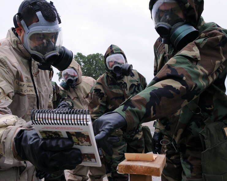 BARKSDALE AIR FORCE BASE, La. ? Team Alpha matches the color on the M8 paper to their Airman?s Manual during the emergency management training held June 6. This training covers a wide variety of threats that may potentially occur on Air Force installations. (U.S. Air Force photo by Senior Airman La?Shanette V. Garrett)(RELEASED)