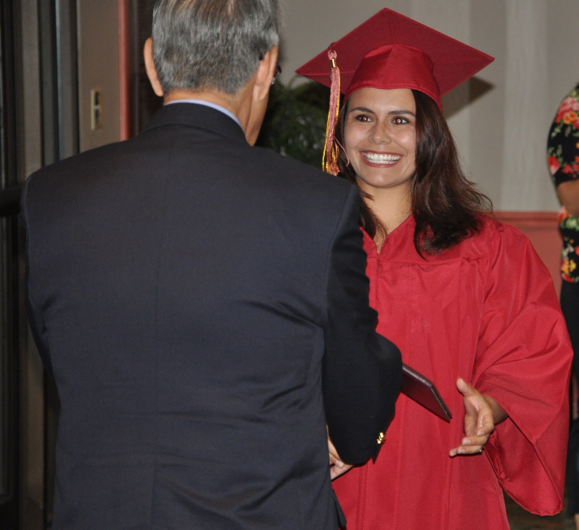 LAUGHLIN AIR FORCE BASE, Texas – Senior Airman Carolina Henderson, 47th Security Forces Squadron, receives her diploma from Dr. Gregory Garcia, Park University’s director of distance academic services, upon graduating from Park with an associate degree in Social Psychology during a graduation ceremony for graduates of Park, Troy University, Norwich University and the Community College of the Air Force at Club XL here June 9. Several Laughlin members celebrated their commencement by participating in the ceremony and even more graduated but were unable to participate. A total of 39 Laughlin members completed their degrees. (U.S. Air Force photo by Airman 1st Class Blake Mize)