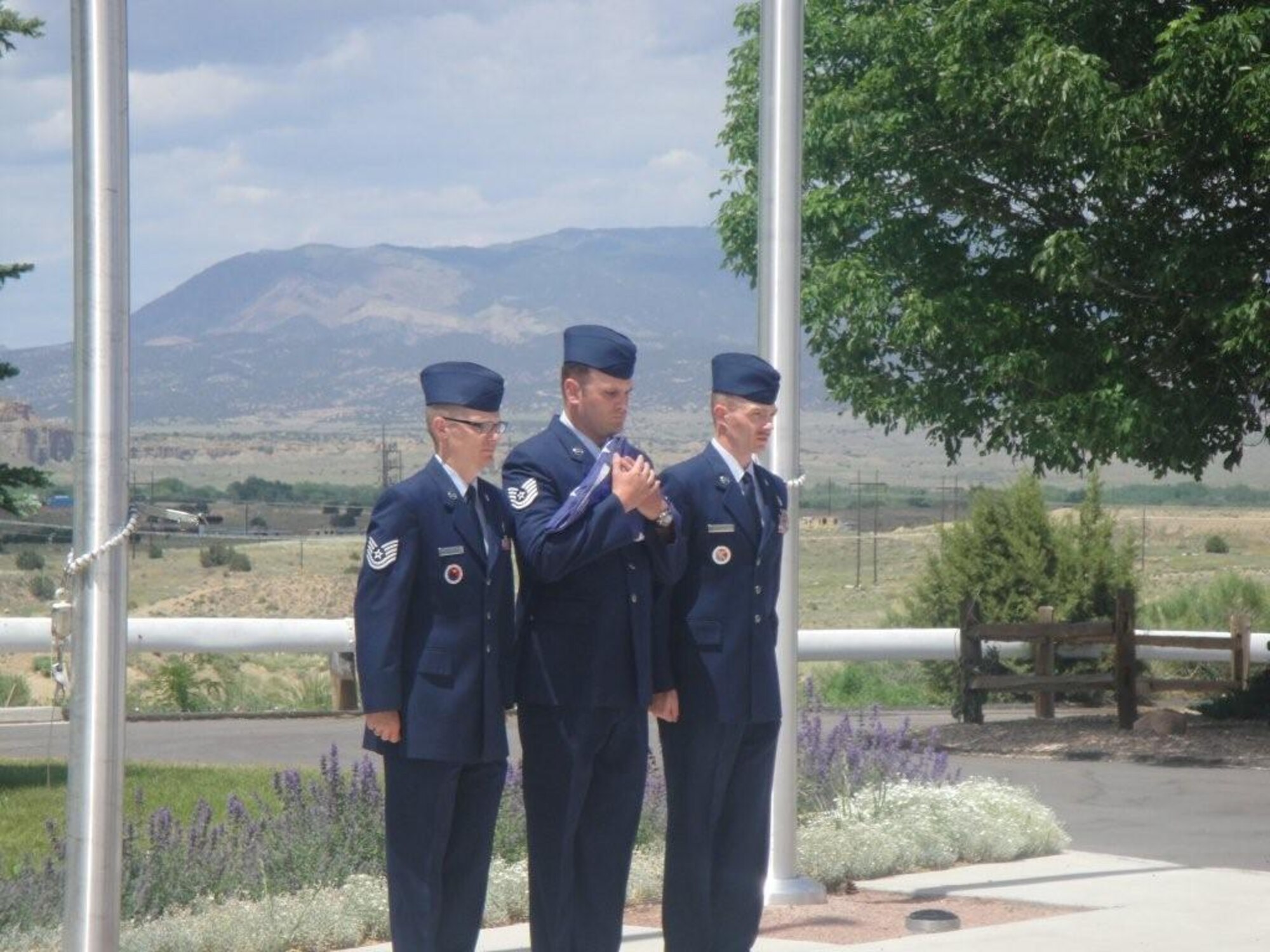 Tech. Sgt. Paul Breckon (left), Tech. Sgt. Todd Badger (center), and Master Sgt. Anthony Abler prepare to retire an old U.S. flag June 2 at the Bruce McCandless VA nursing home in Florence, Colo. Staff members from the Vosler NCOA donated a flag to the home, replacing and retiring a weathered flag that was flying there. (Courtesy photo)