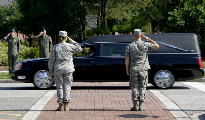 The remains of a U.S. Army noncommissioned officer are transported down the main thoroughfare of Joint Base Charleston, S.C., mid-morning June 11, 2010, as the Airmen lining the street salute the fallen comrade. The journey to a final resting place was made from the Middle East by way of Dover Air Force Base, Del., where the remains were meticulously prepared for military burial by the Mortuary Affairs Operations Center. U.S. Army honor guard members from Fort Jackson, S.C., received the remains upon arrival to JB CHS. (U.S. Air Force photo/Staff Sgt. Daniel Bowles)