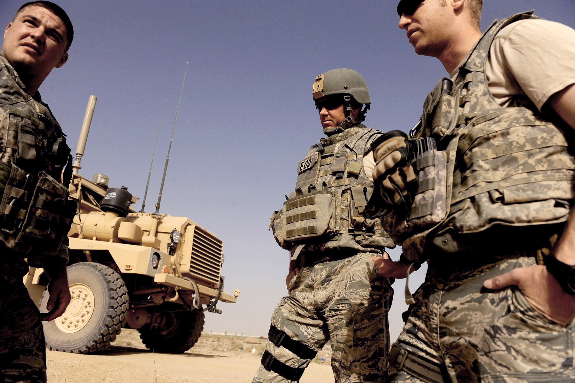 Tech. Sgt. David Niedzwiadek (left to right), Master Sgt. Donald Moore and Capt. Andrew Clemmensen speak about the day's mission June 4, 2010, in Kandahar City, Afghanistan. The The Airmen are assigned to explosive ordnance disposal technicians assigned to the 755th Air Expeditionary Squadron, Operating Location-Bravo explosive ordnance disposal team. (U.S. Air Force photo/Staff Sgt. Manuel J. Martinez)