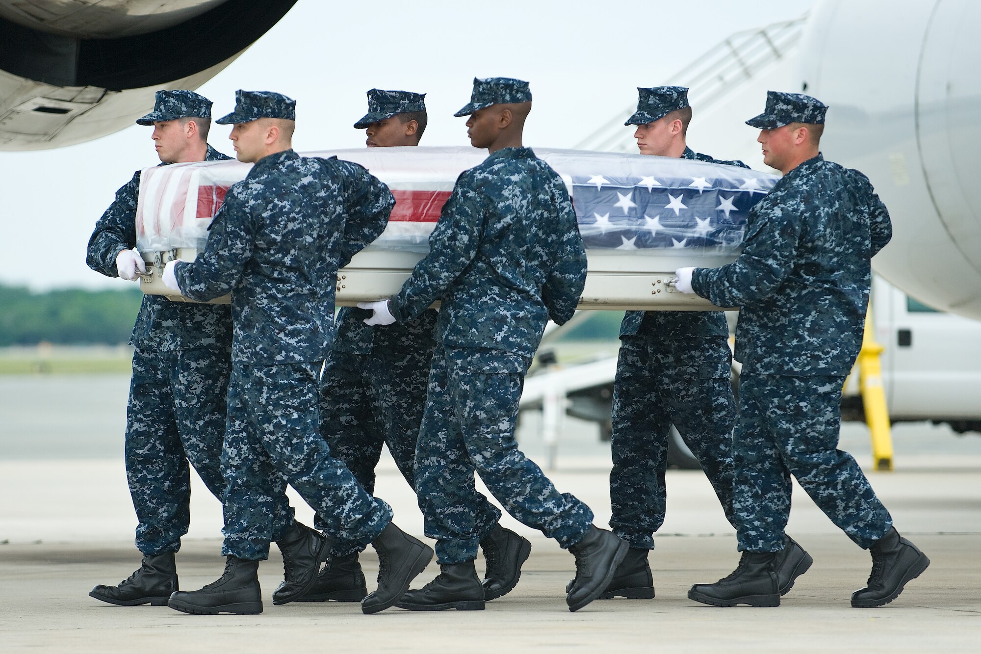 A U.S. Navy team transfers the remains of Navy Petty Officer 3rd Class Zarian A. Wood, of Houston, Texas, at Dover Air Force Base, Del., May 17. Petty Officer Wood was assigned as a hospital corpsman to Third Battalion, First Marine Regiment, First Marine Division, I Marine Expeditionary Force. (U.S. Air Force photo/Roland Balik)