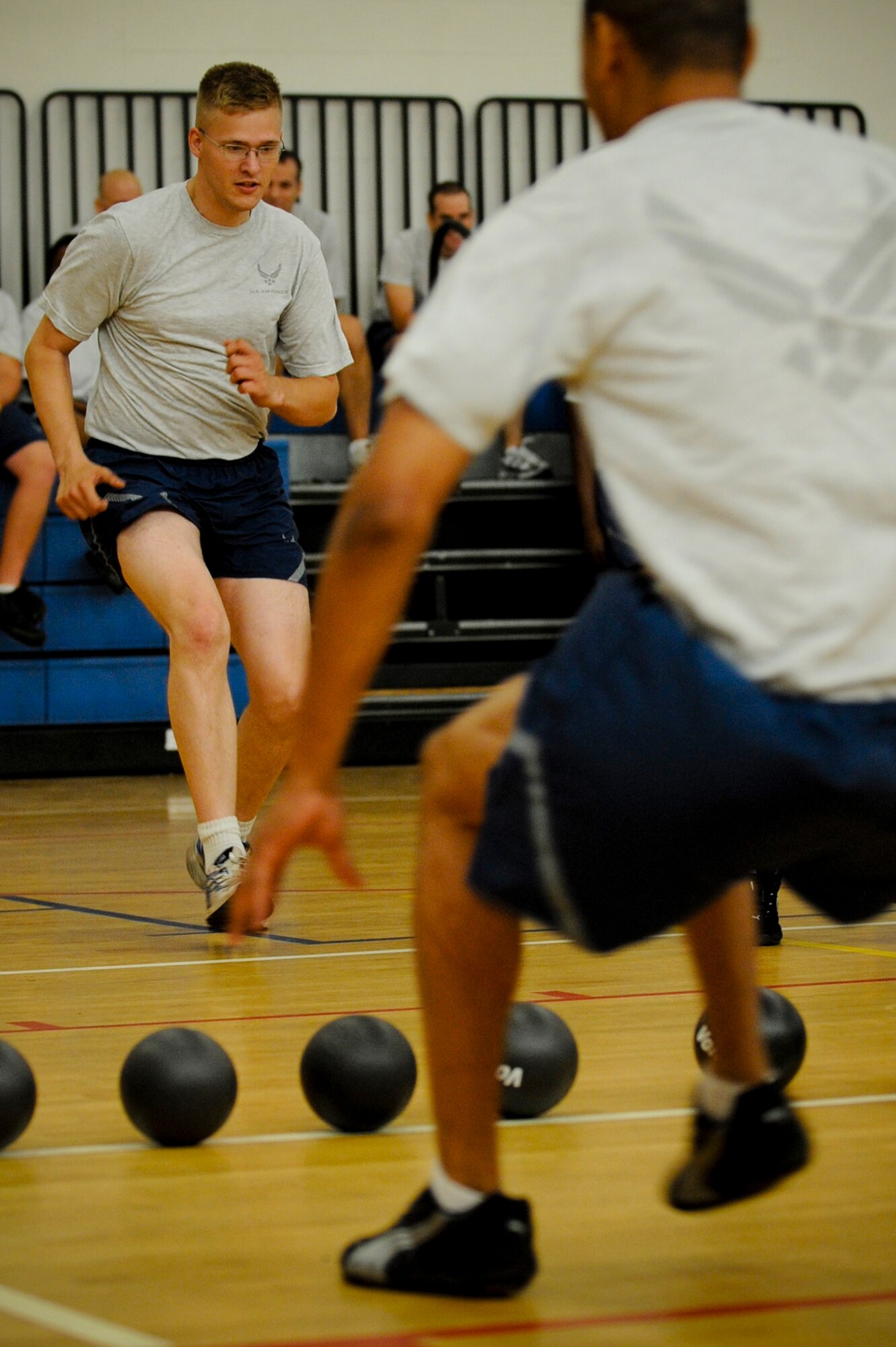 Airman Darek Baczewski, 6th Air Mobility Wing Public Affairs, races toward the center of the court to start a game of dodgeball during the 6th Air Mobility Wing Sports Day at MacDill Air Force Base, Fla., Jun. 11, 2010.  Members from the 6 AMW participated in a number of different sporting events during Sports Day to promote fun and camaraderie.  (U.S. Air Force photo by Staff Sgt. Joseph L. Swafford Jr./Released)