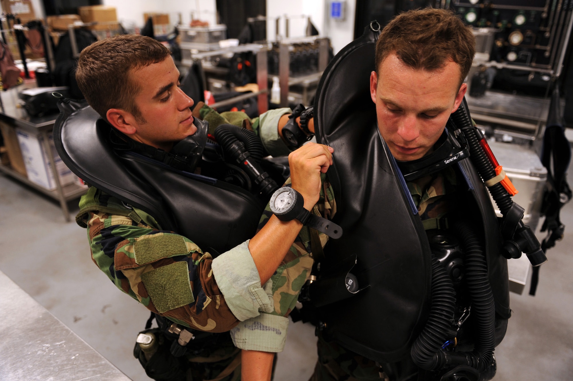 Airmen assist their wingmen with dive gear before heading out for an early morning dive during their combat dive course June 10, 2010, at Panama City Beach, Fla. The Airmen are combat controllers in training assigned to the 342nd Training Squadron Det. 2. (U.S. Air Force photo/Staff Sgt. Desiree N. Palacios)
