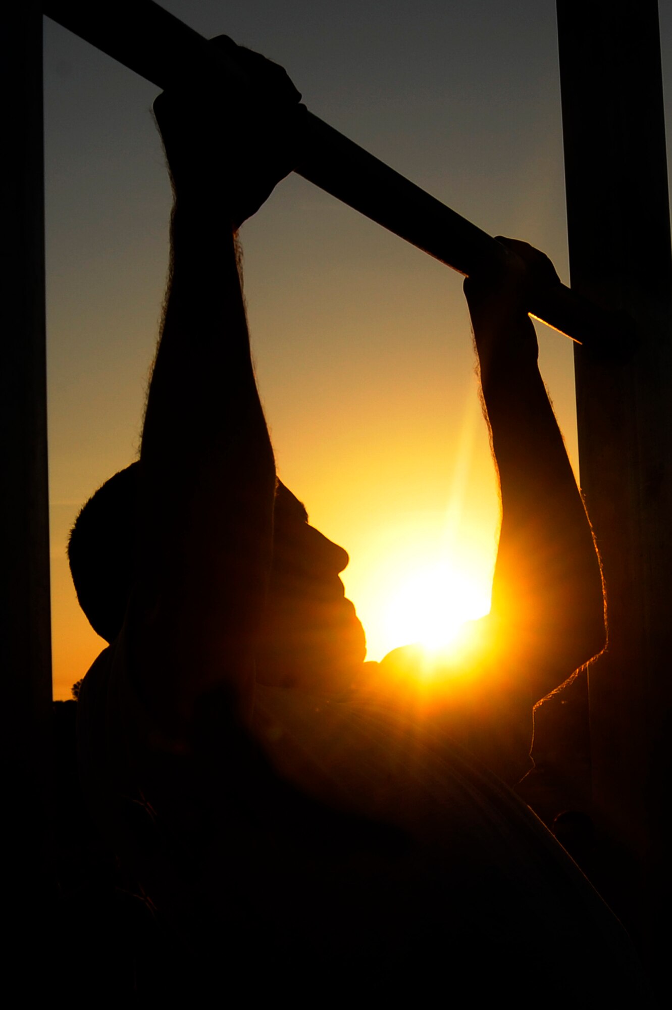 A 6th Air Mobility Wing Airman competes in the pull up competition during the 6th AMW Sports Day at MacDill Air Force Base, Fla., Jun. 11, 2010.  Members from the 6 AMW participated in a number of different sporting events during Sports Day to promote fun and camaraderie.  (U.S. Air Force photo by Staff Sgt. Joseph L. Swafford Jr./Released)