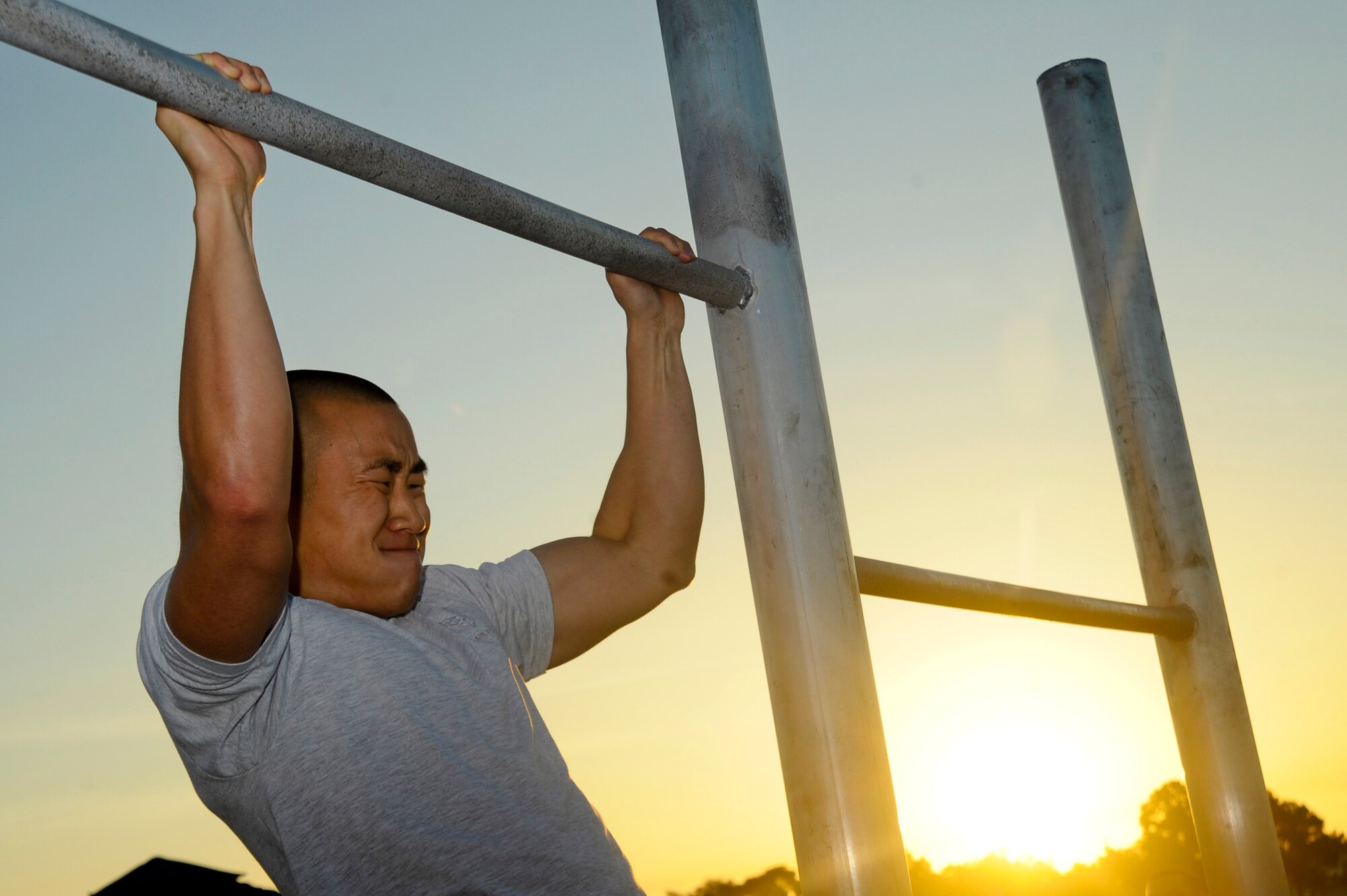 Airman 1st Class David Yi, 6th Aircraft Maintenance Squadron, competes in the pull up competition during the 6th Air Mobility Wing Sports Day at MacDill Air Force Base, Fla., Jun. 11, 2010.  Members from the 6 AMW participated in a number of different sporting events during Sports Day to promote fun and camaraderie.  (U.S. Air Force photo by Staff Sgt. Joseph L. Swafford Jr./Released)