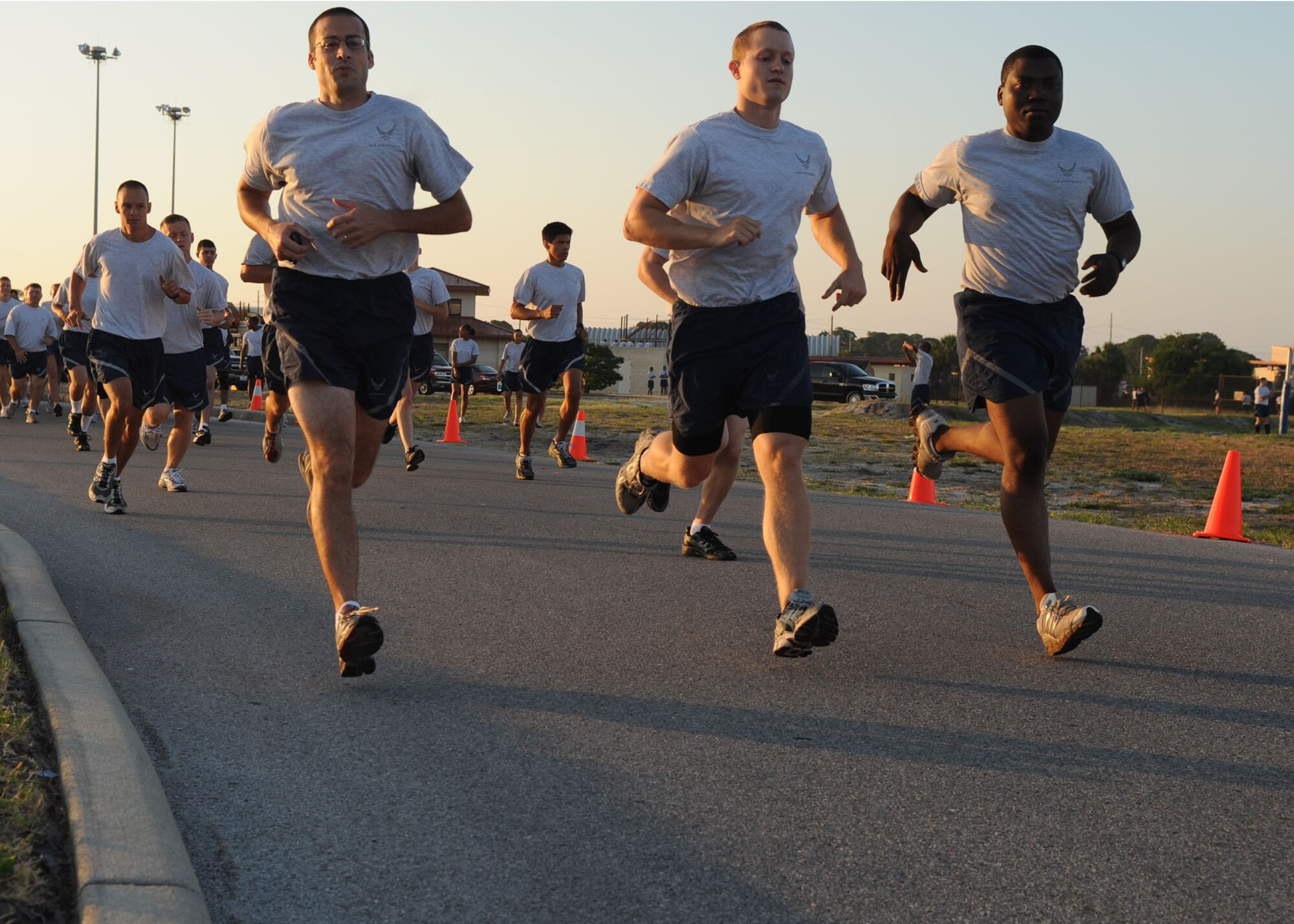 Airman of the 6th Air Mobility Wing run ahead of the crowd in the 5K run during the 6th Air Mobility Wing Sports Day at MacDill Air Force Base, Fla., June 11, 2010.  Members from the 6 AMW participated in a number of different sporting events during Sports Day to promote fun and camaraderie.   
(U. S. Air Force photo by Senior Airman Linzi Joseph)	
