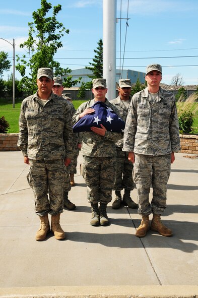 Members of the 914th Airlift Wing present the United States flag during retreat, June 5. (U.S. Air Force photo by Staff Sgt Stephanie Clark)