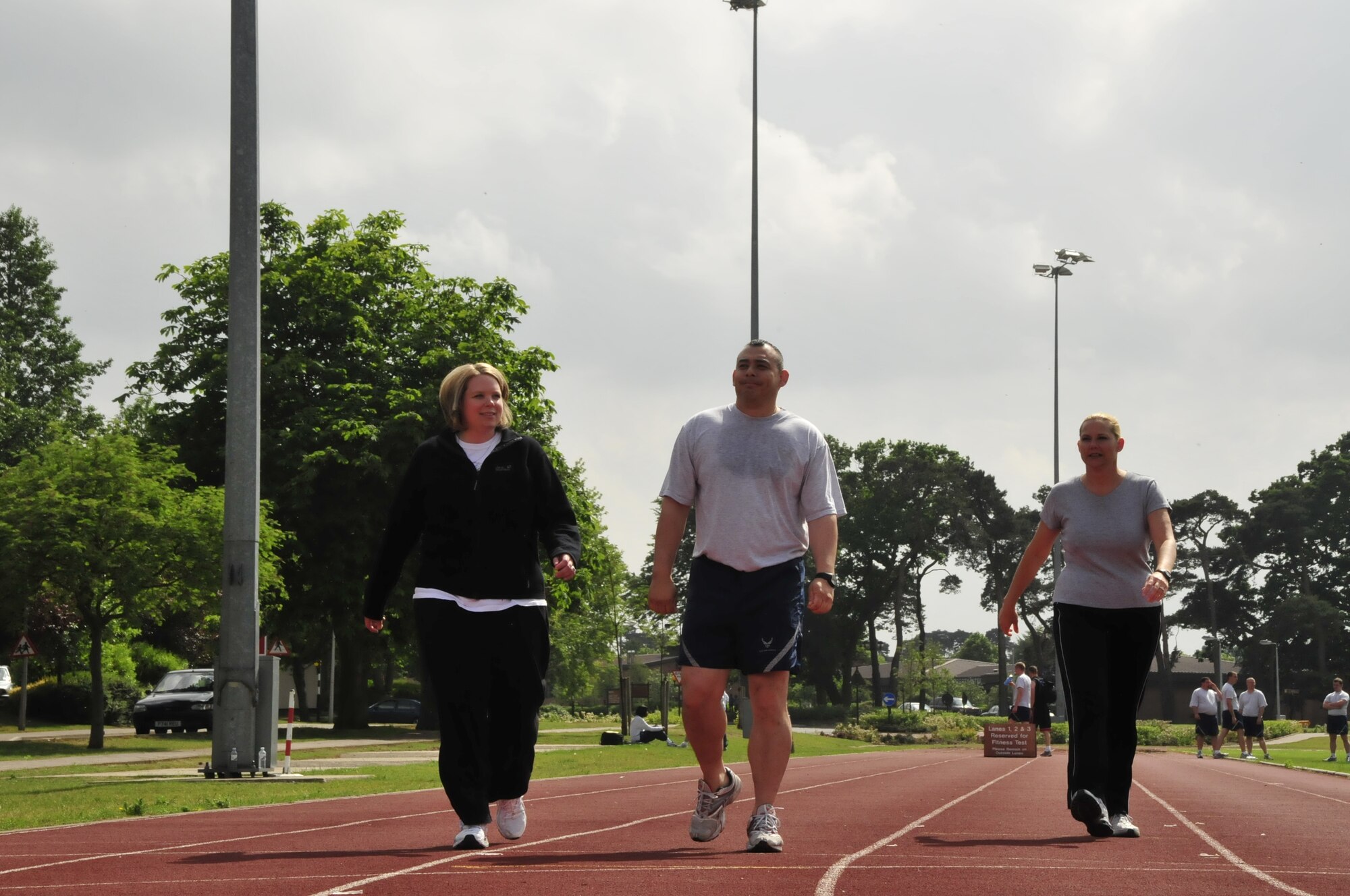 From left to right Maj. Karen Kramer, 48th Aerospace Medicine Squadron public health operations chief, Master Sgt. Carlos Martinez, 48th Aerospace Medicine Squadron superintendent and Jennifer Craig, 48th Aerospace Medicine Squadron Public Health flight administrator, walk around the RAF Lakenheath track Jun 11. They were taking part of a walking challenge, called “Step into Spring,” hosted by the Health and Wellness Center.(U.S. Air Force photo/Airman 1st Class Eboni Knox)