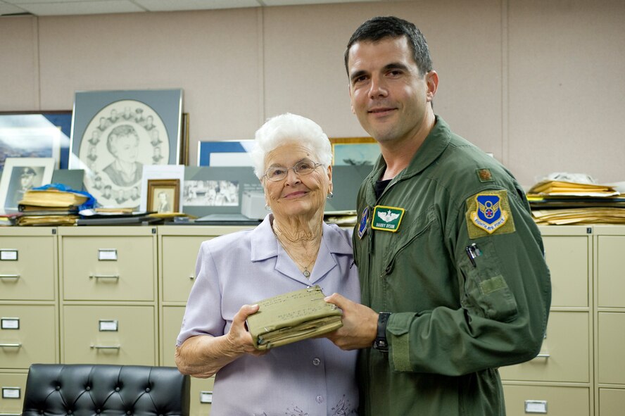 BARKSDALE AIR FORCE BASE, La. -- Joy Bolesta, wife of the late Maj. Stanley Bolesta, presents her husband's journal to Maj. Harry Dyson, 2d Bomb Wing Director of Staff, during a visit to the Eighth Air Force Museum June 9. Major Bolesta wrote the journal during his time in the German POW camp Stalag Luft 1 during World War II. (U.S. Air Force photo/Senior Airman Chad Warren)