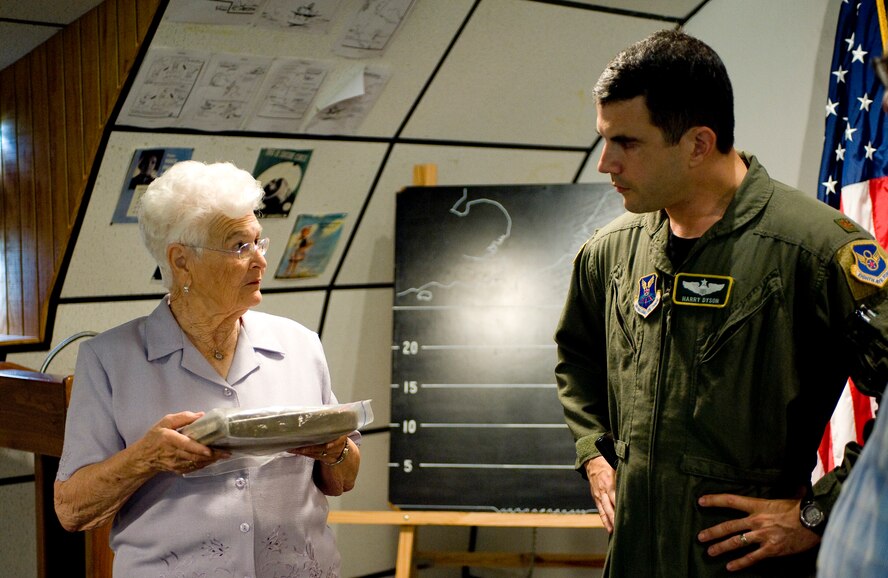 BARKSDALE AIR FORCE BASE, La. -- Joy Bolesta, wife of the late Maj. Stanley Bolesta, talks to Maj. Harry Dyson, 2d Bomb Wing Director of Staff, while holding the journal her husband wrote while being held as a prisoner of war during World War II. Major Bolesta's B-26 was shot down over France in November of 1943 and was held in the German POW camp Stalag Luft 1 until he was liberated in 1945. (U.S. Air Force photo/Senior Airman Chad Warren)