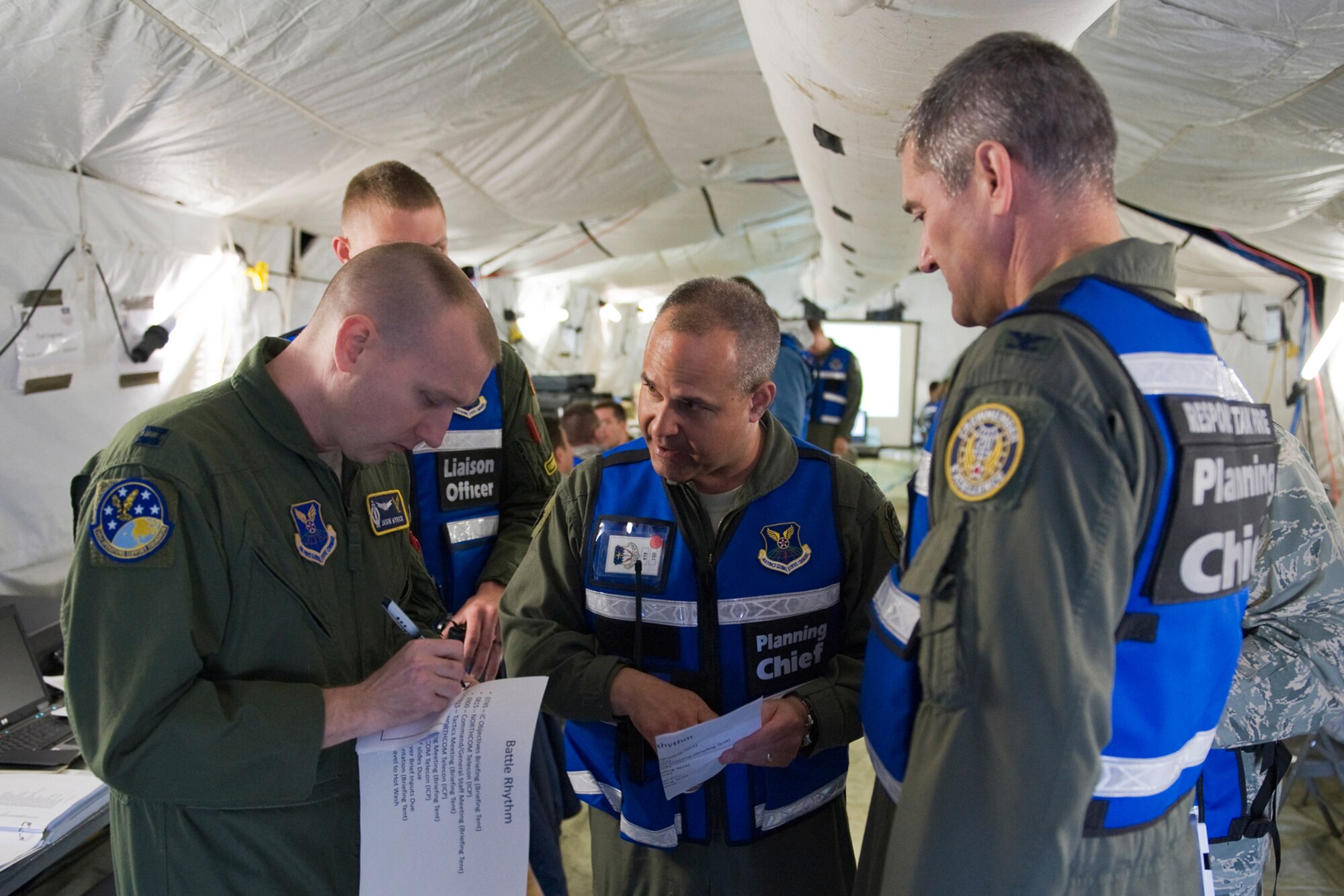 Col. Mohammed Khan discusses an exercise scenario with Capt. David Wyrick as Col. Paul Gydesen looks on during a four-day multi-faceted exercise June 1 through 4, 2010, at Malmstrom Air Force Base, Mont. Colonel Khan is the 341st Operations Group commander. Captain Wyrick is with the 341st Operations Support Squadron. Colonel Gydesen is the Air Force Global Strike Command deputy director for Plans, Programs and Requirements. (U.S. Air Force photo/Beau Wade) 
