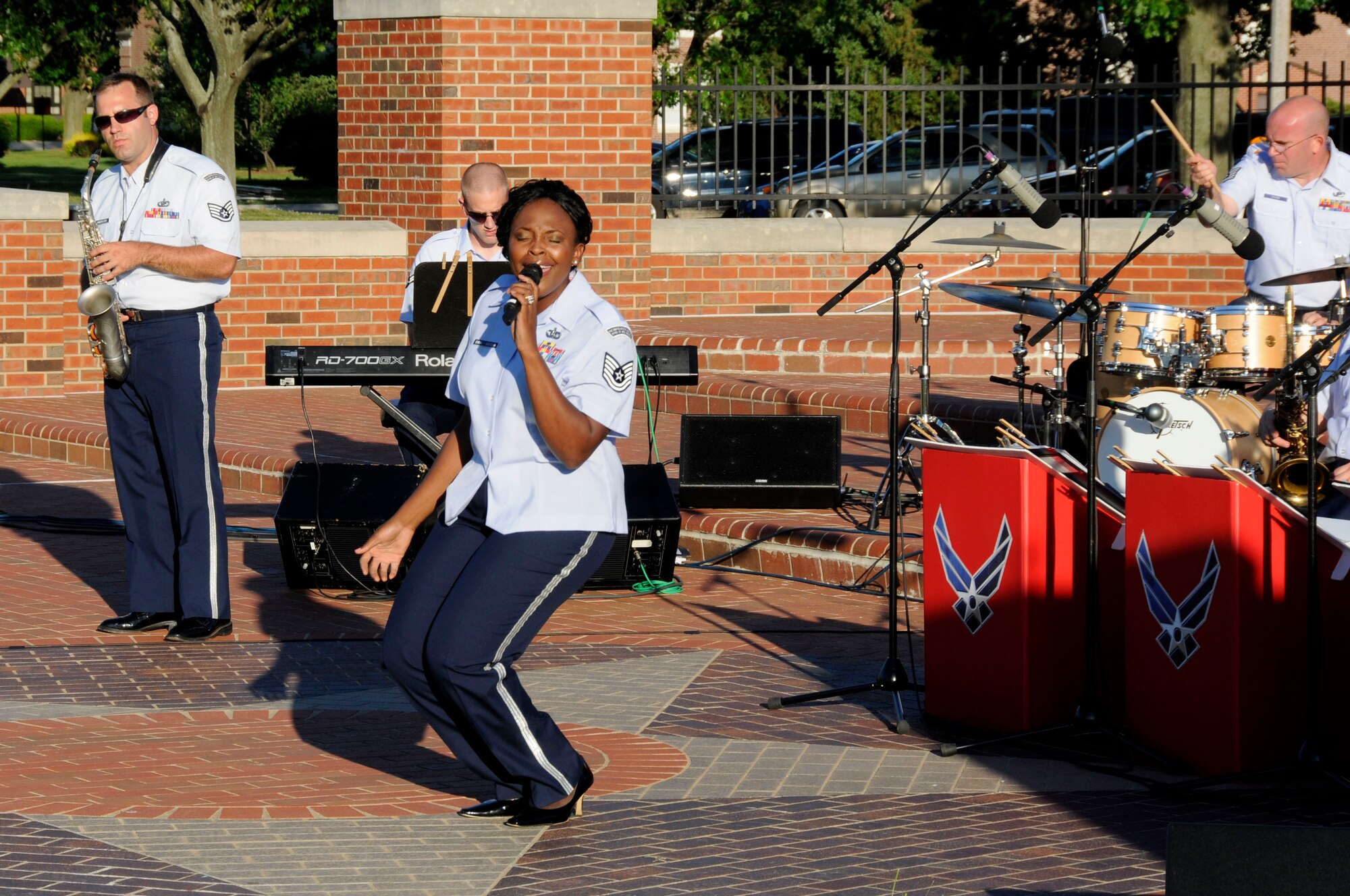 Tech. Sgt. Keisha Gwin-Goodin gets down during her performance of Aretha Franklin's "Think" during the United States Air Force Band of Mid-America's concert at Scott AFB parade field, June 6, 2010. The Shades of Blue Jazz Ensemble performed in front of Team Scott to kick off the summer concert series. Upcoming performances in the summer concert series include Starlifter, Aug. 1, and the concert band Aug. 29. (U.S. Air Force photo by Staff Sgt. Brian J. Ellis)