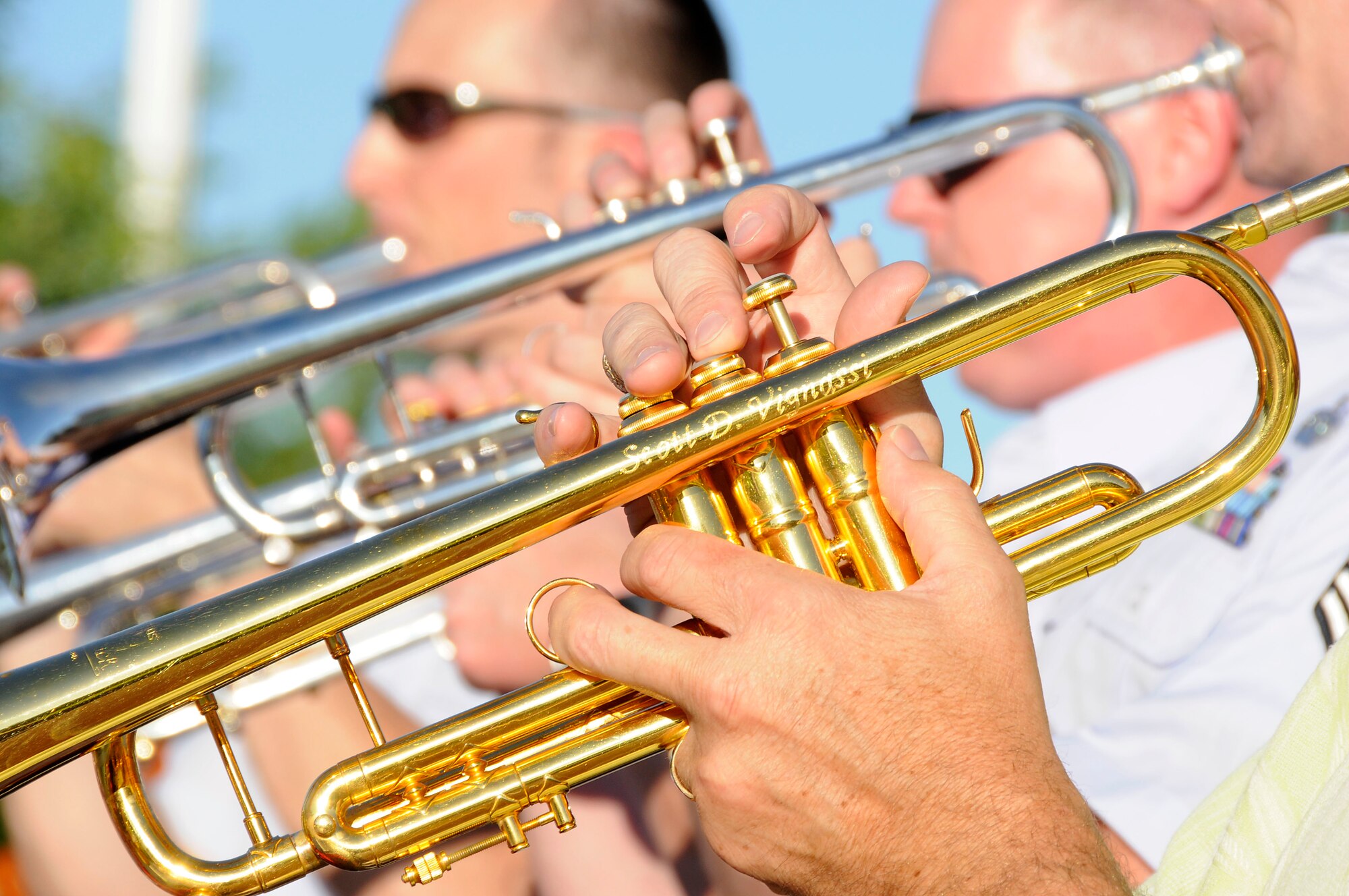 The trumpet section plays during the United States Air Force Band of Mid-America's concert at Scott AFB parade field, June 6, 2010. The Shades of Blue Jazz Ensemble performed in front of Team Scott to kick off the summer concert series. Upcoming performances in the summer concert series include Starlifter, Aug. 1, and the concert band Aug. 29. (U.S. Air Force photo by Staff Sgt. Brian J. Ellis)