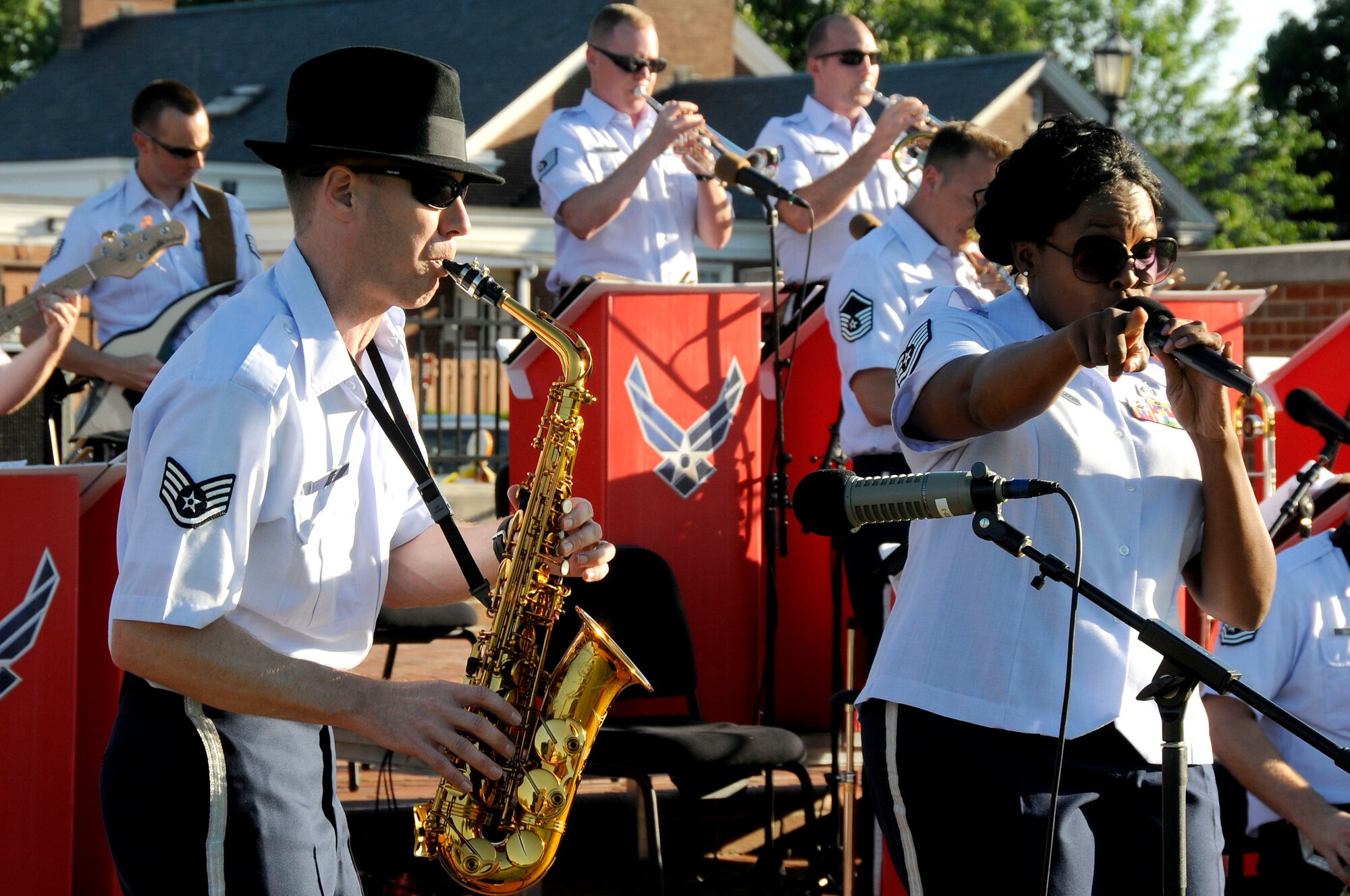 Staff Sgt. Dwight Wiest and Tech. Sgt. Keisha Gwin-Goodin perform during the United States Air Force Band of Mid-America's concert at Scott AFB parade field, June 6, 2010. The Shades of Blue Jazz Ensemble performed in front of Team Scott to kick off the summer concert series. Upcoming performances in the summer concert series include Starlifter, Aug. 1, and the concert band Aug. 29. (U.S. Air Force photo by Staff Sgt. Brian J. Ellis)