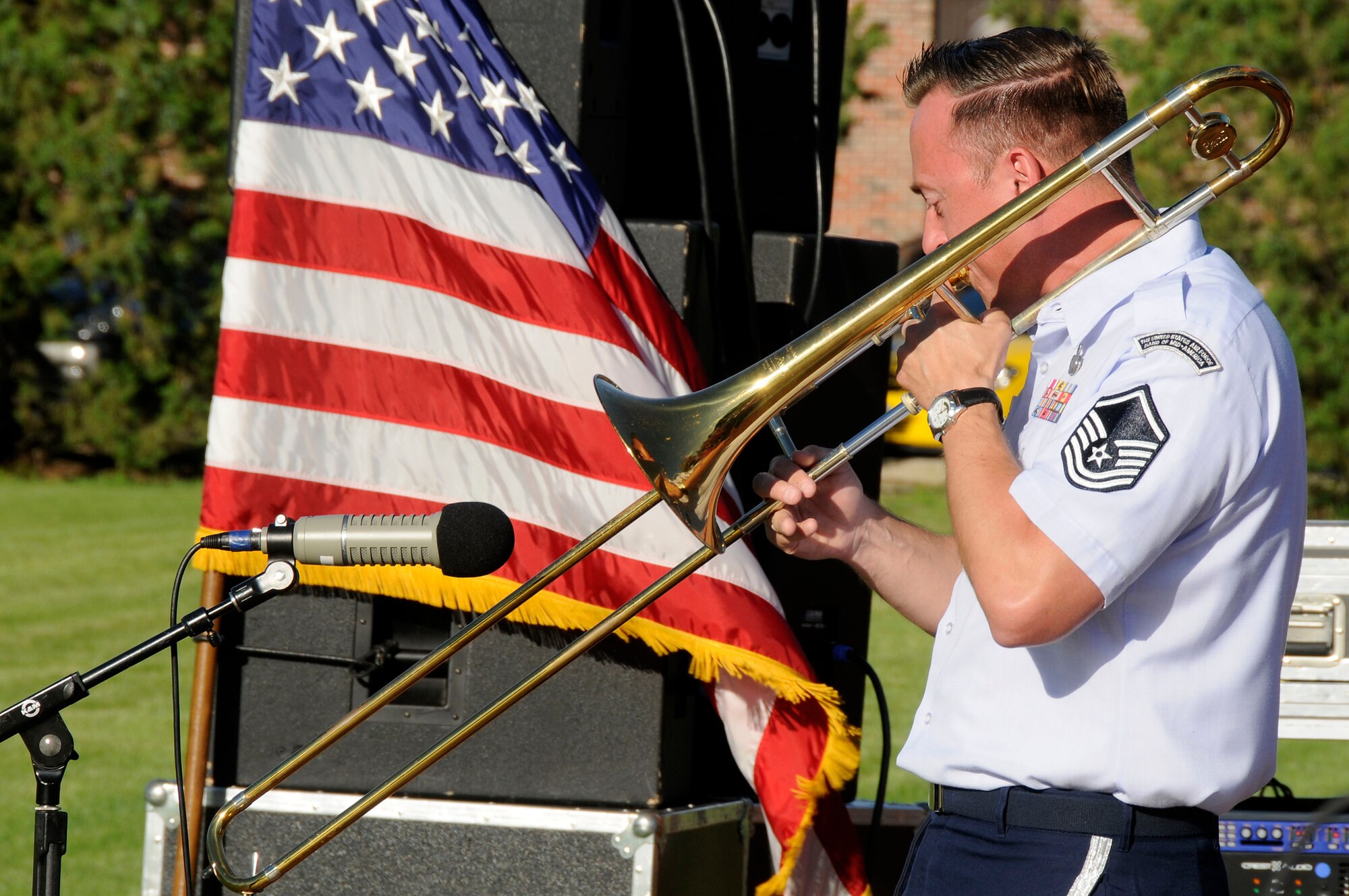 Master Sgt. Rick Thorp plays his trombone during the United States Air Force Band of Mid-America's concert at Scott AFB parade field, June 6, 2010. The Shades of Blue Jazz Ensemble performed in front of Team Scott to kick off the summer concert series. Upcoming performances in the summer concert series include Starlifter, Aug. 1, and the concert band Aug. 29. (U.S. Air Force photo by Staff Sgt. Brian J. Ellis)