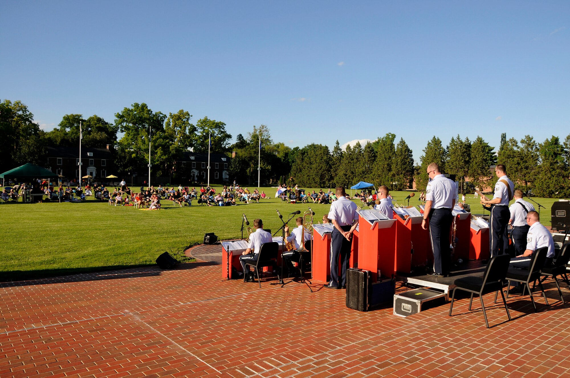 Scott Team members watch The United States Air Force Band of Mid-America's Shades of Blue Jazz Ensemble performance at the Scott AFB parade field, June 6, 2010. The performance was the summer concert series kick-off event. Upcoming performances in the summer concert series include Starlifter, Aug. 1, and the concert band Aug. 29. (U.S. Air Force photo by Staff Sgt. Brian J. Ellis)